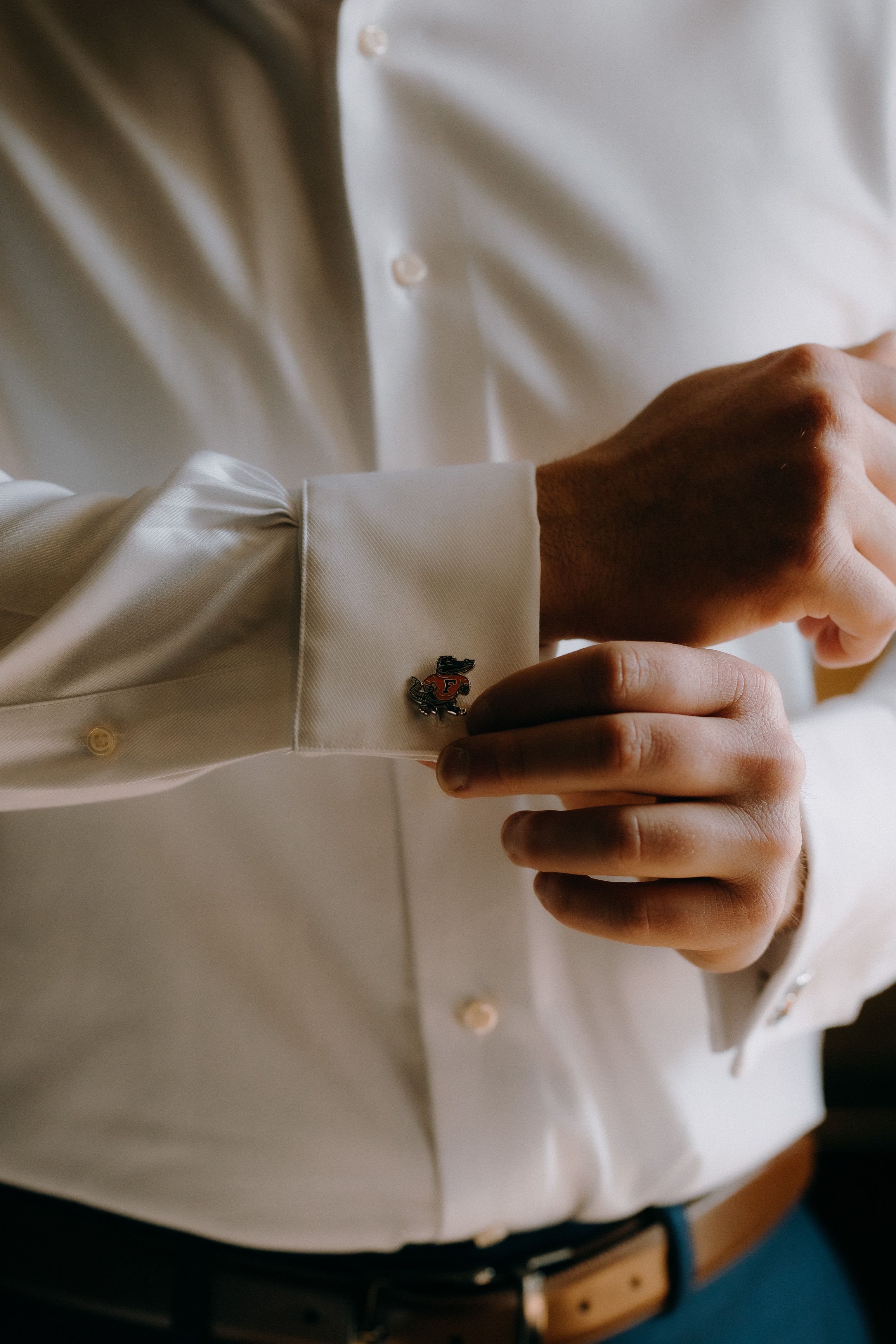 A groom adjusting his Toc Ferro iron cuffs