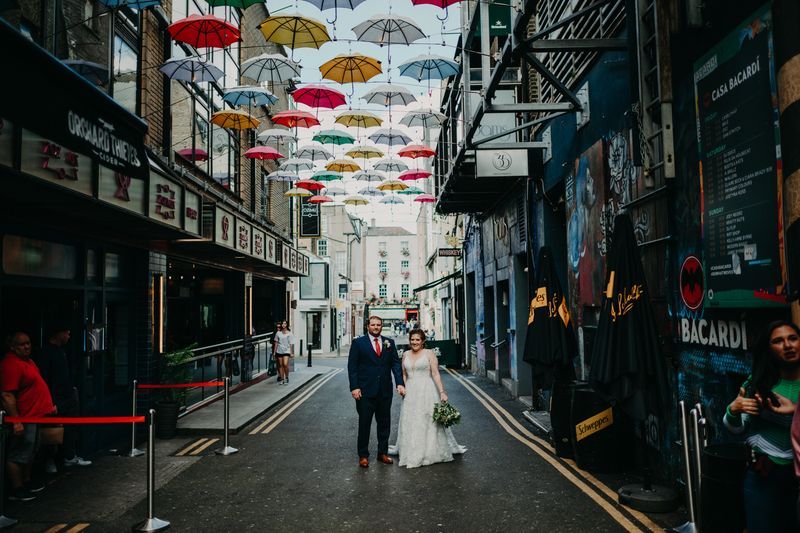 Bride and groom walking though Dublin at their destination wedding in Ireland