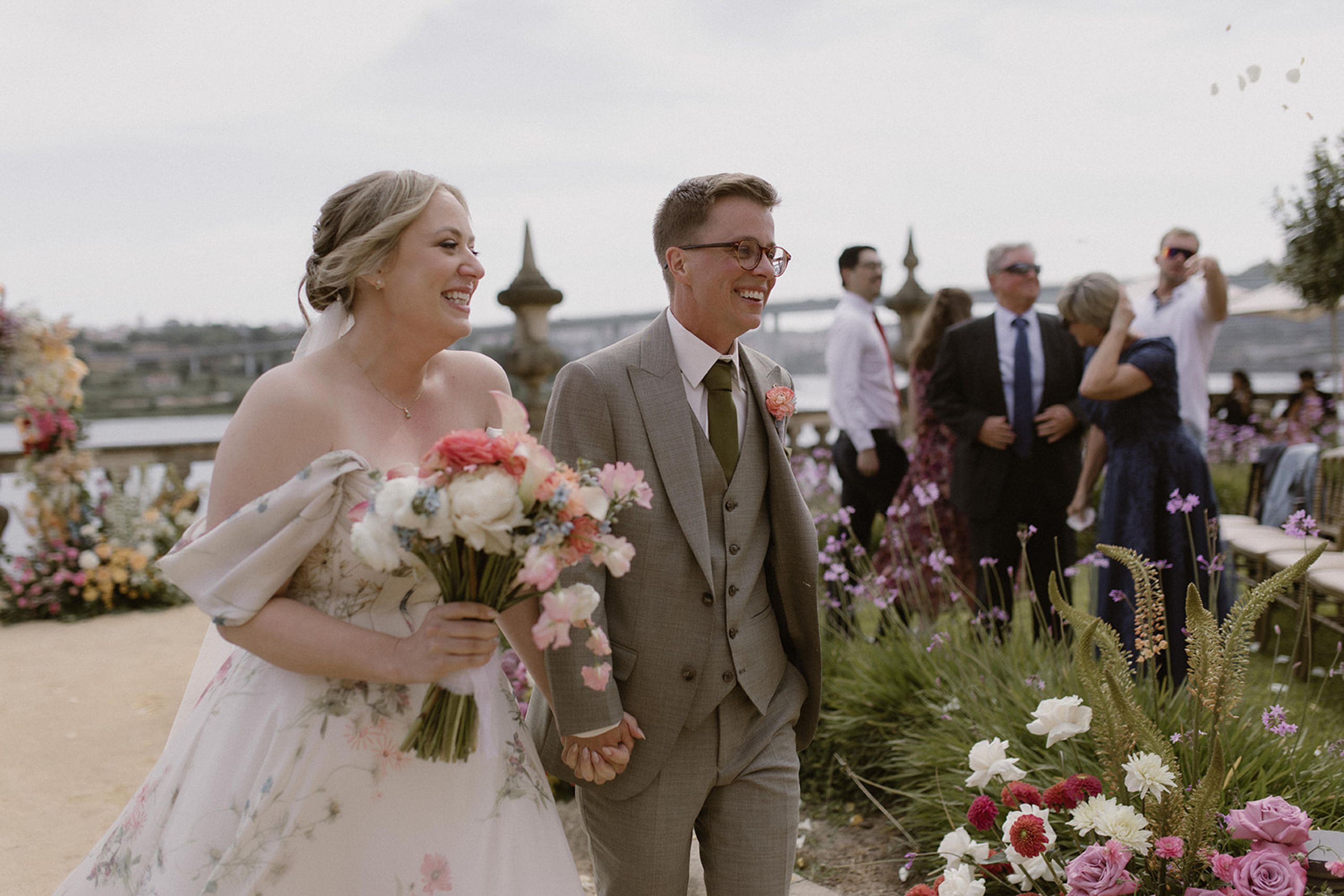 Bride and groom walking hand in hand after the ceremony at an intimate wedding in Portugal