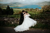 Bride and groom posing for a photo in front of a lake in County Kerry