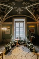 Indoor ceremony space decorated with fresh garden plants with green and white shades for a small wedding in Portugal