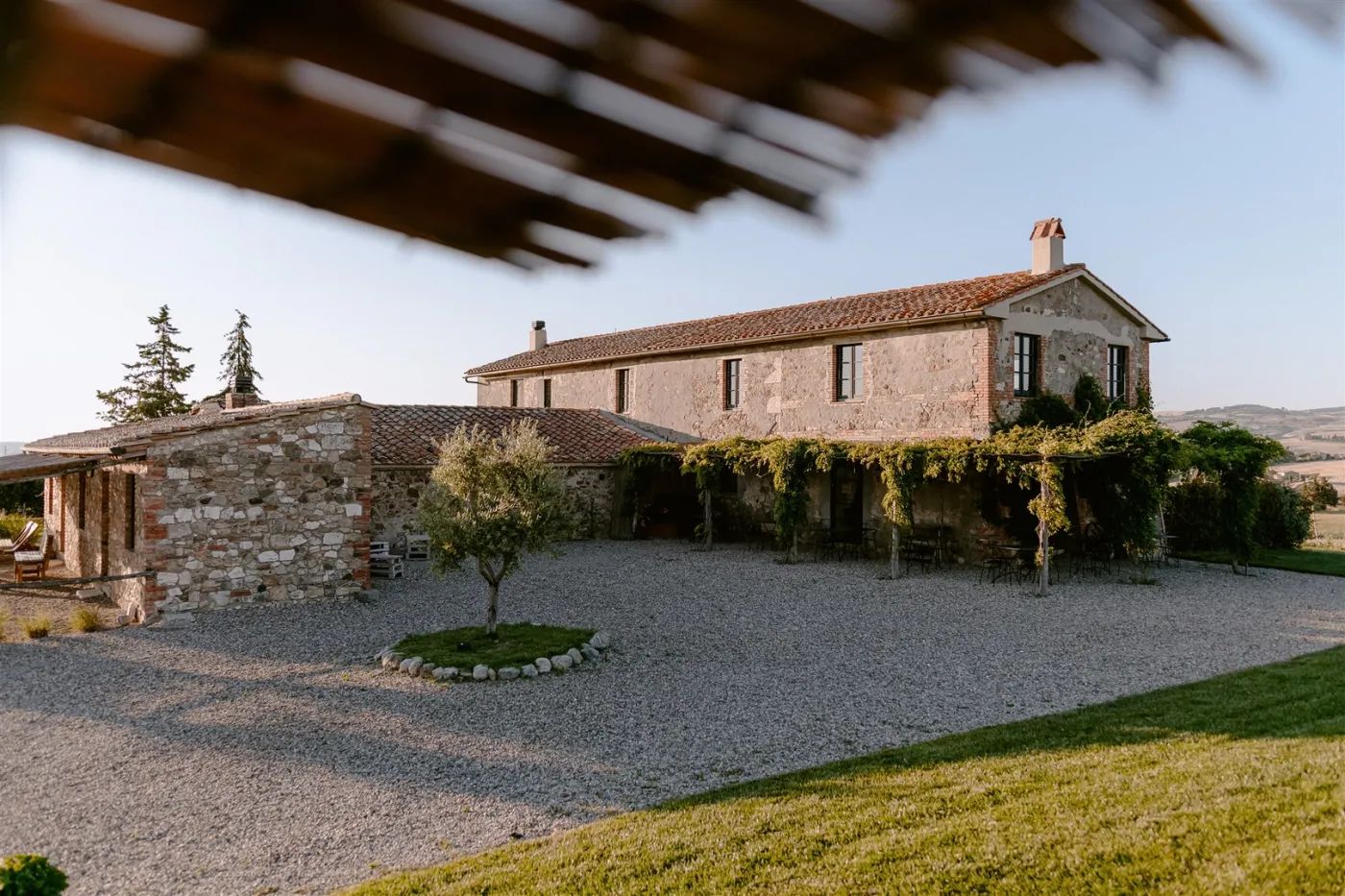 Rustic country house in Siena, Tuscany with a pergola and rolling hills backdrop for Italian weddings abroad