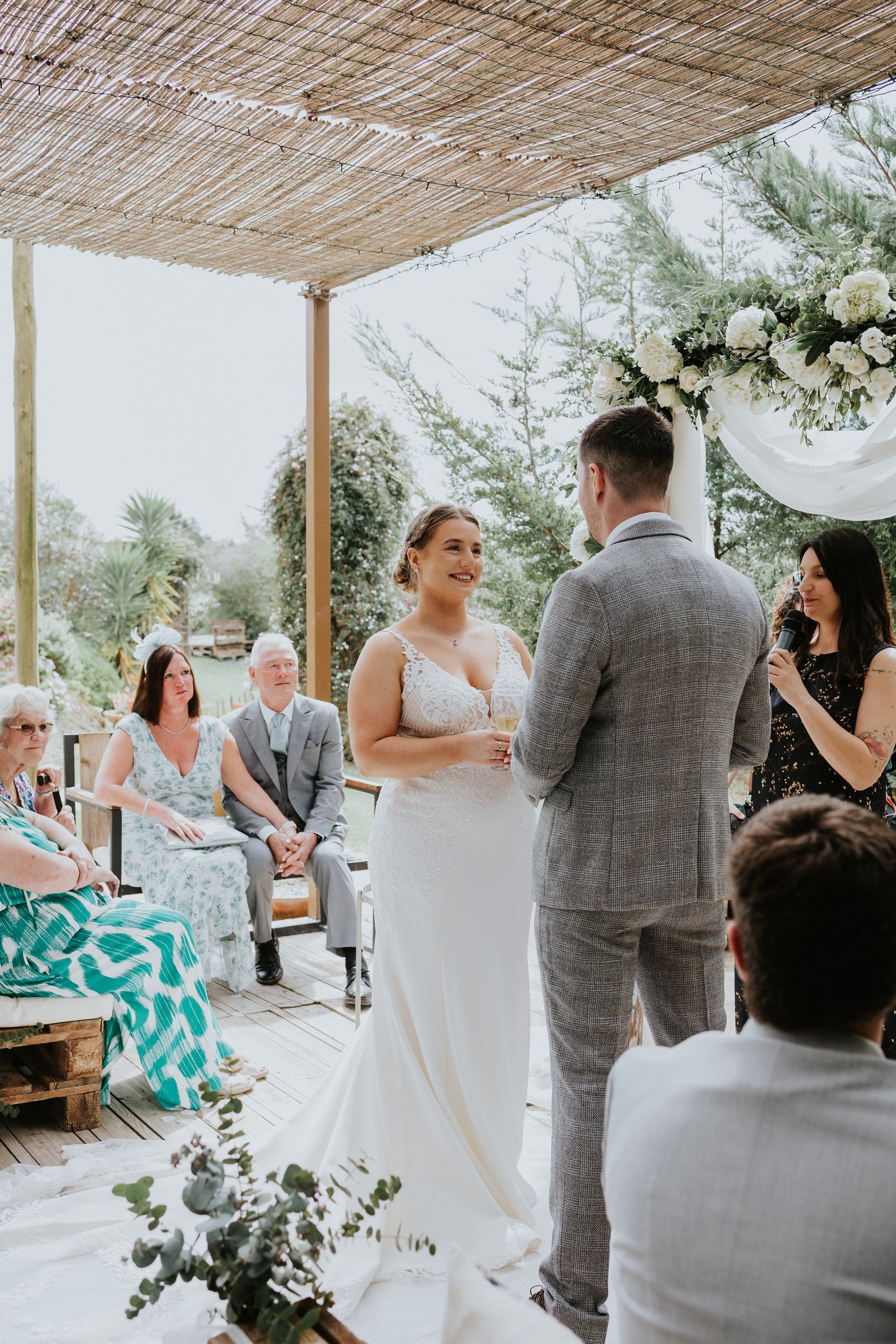 Bride and groom look at each other happily during the ceremony of their intimate wedding in Portugal