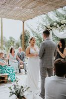 Bride and groom look at each other happily during the ceremony of their intimate wedding in Portugal