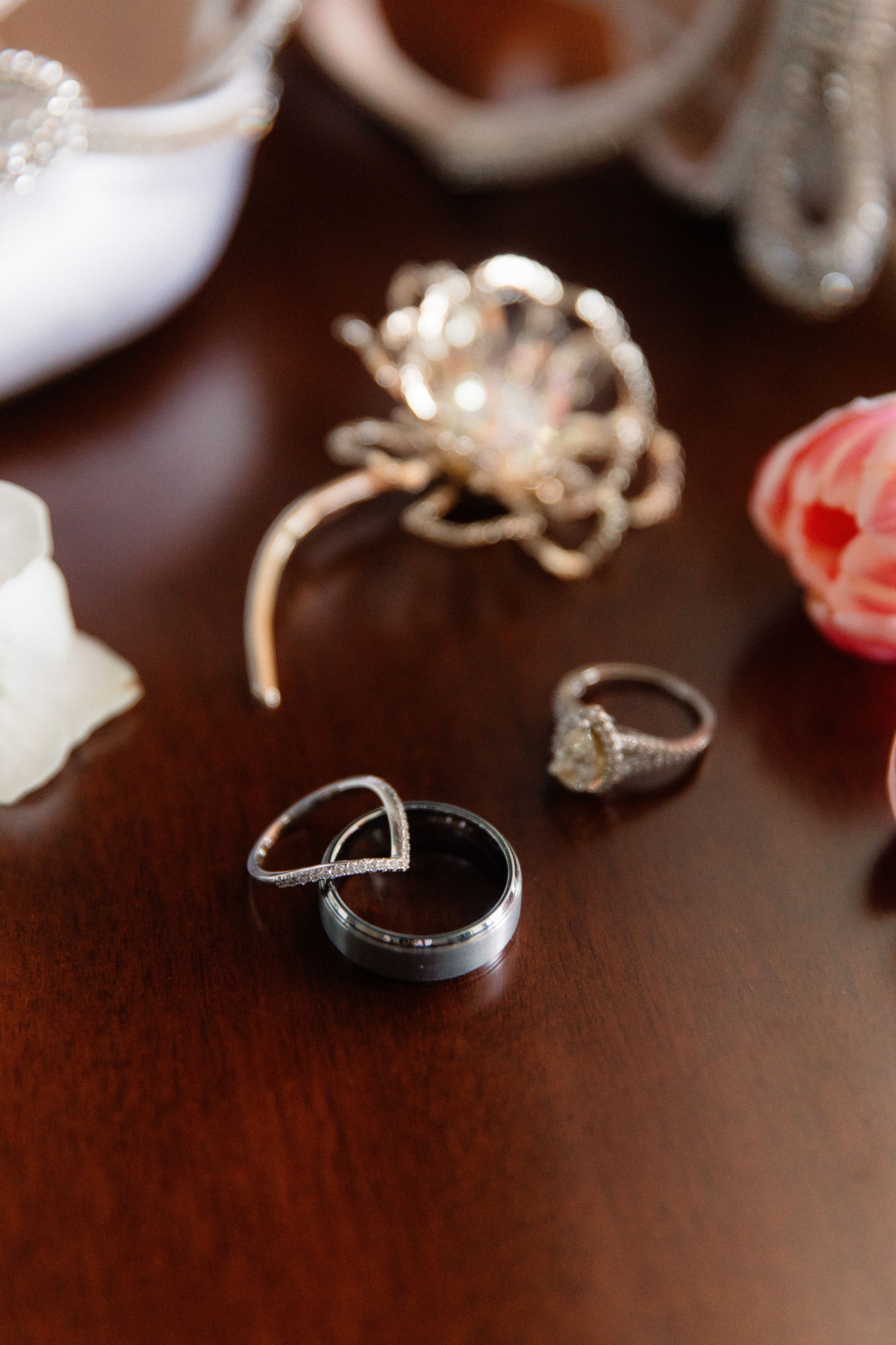 Wedding rings and bridal jewelry arranged on a wooden table before an intimate wedding in Italy ceremony