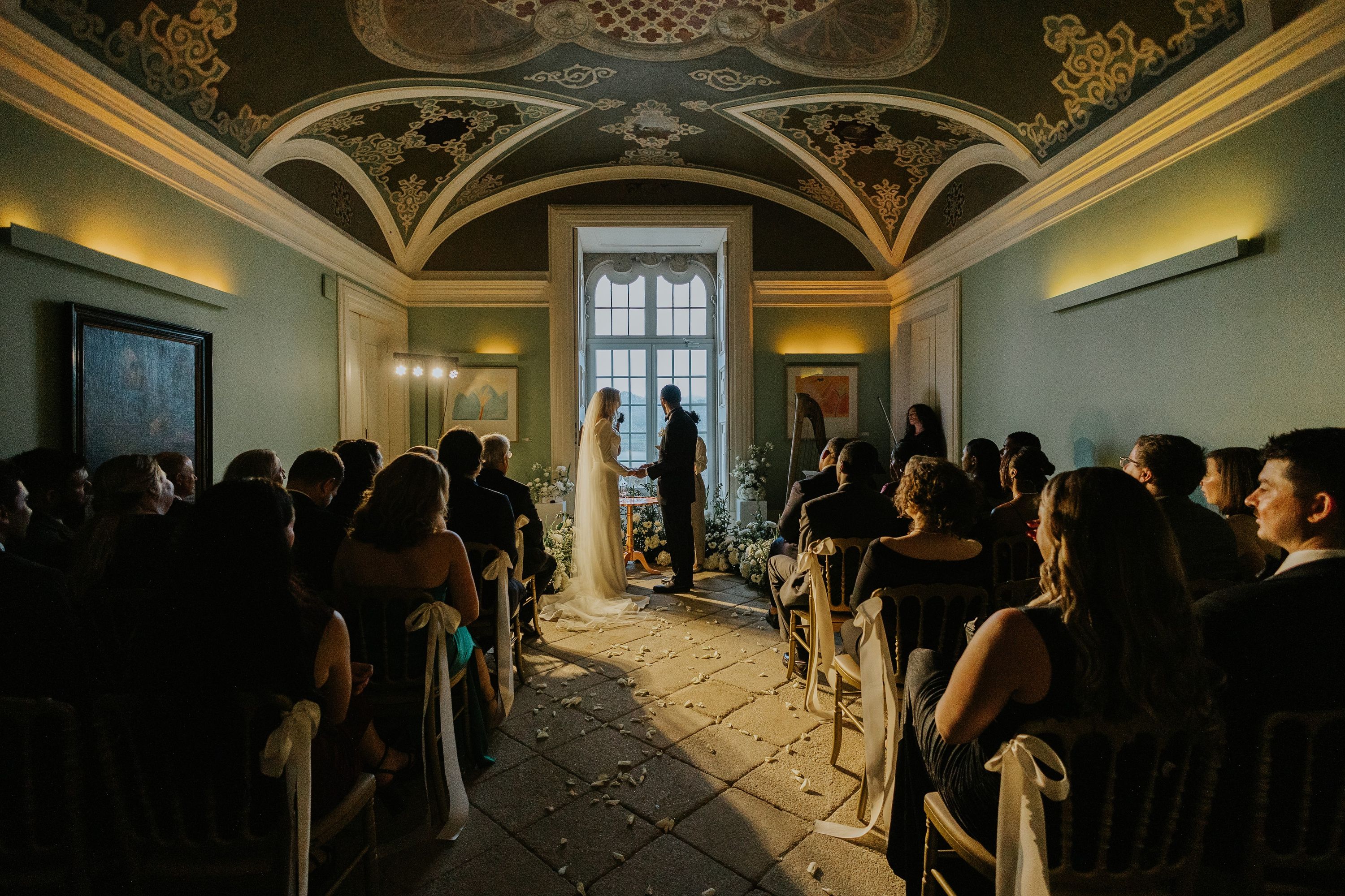 Couple in a wedding ceremony inside a dome-shaped castle event room in Portugal