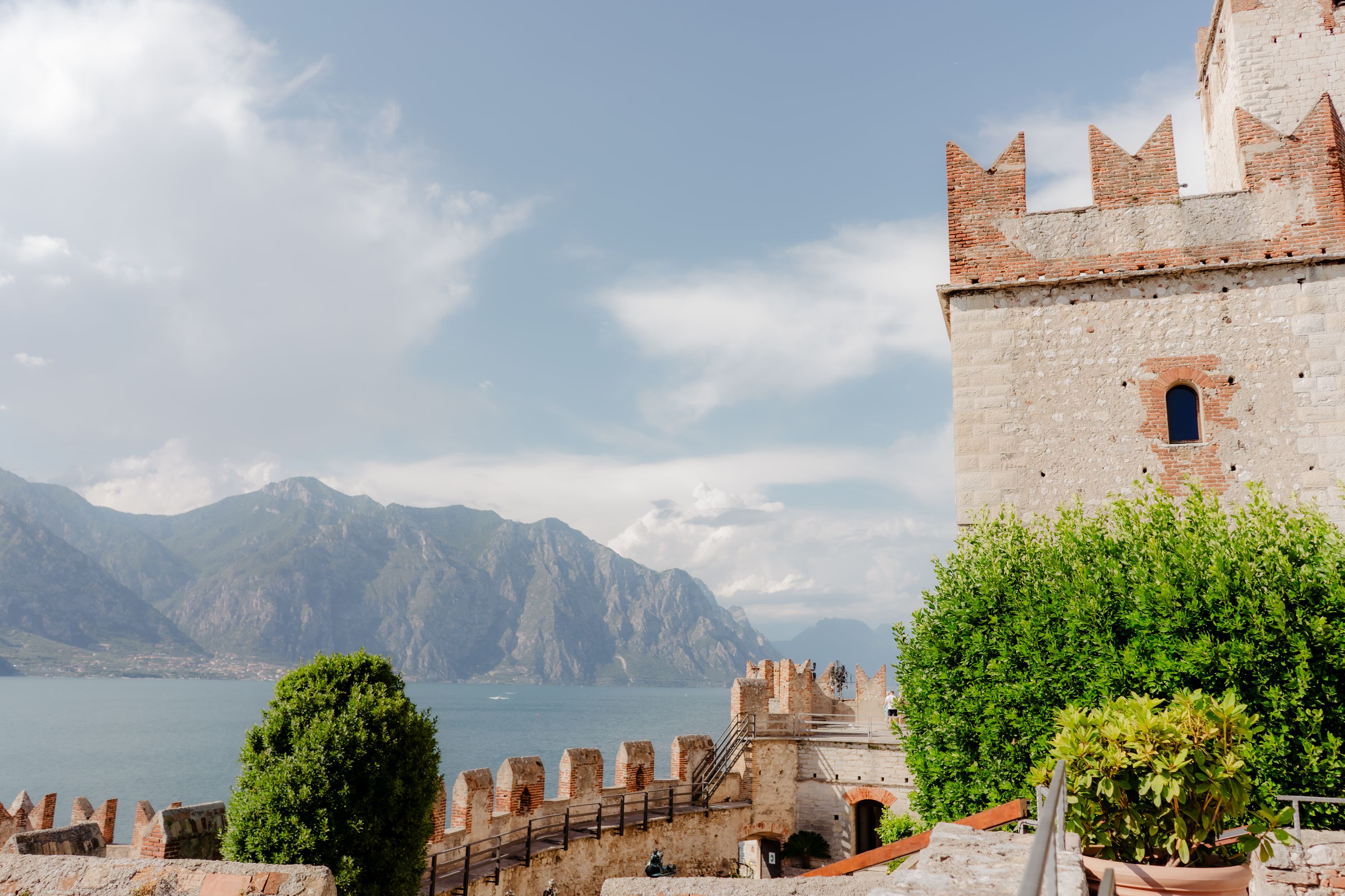 Historic castle with a mountain backdrop along Lake Garda