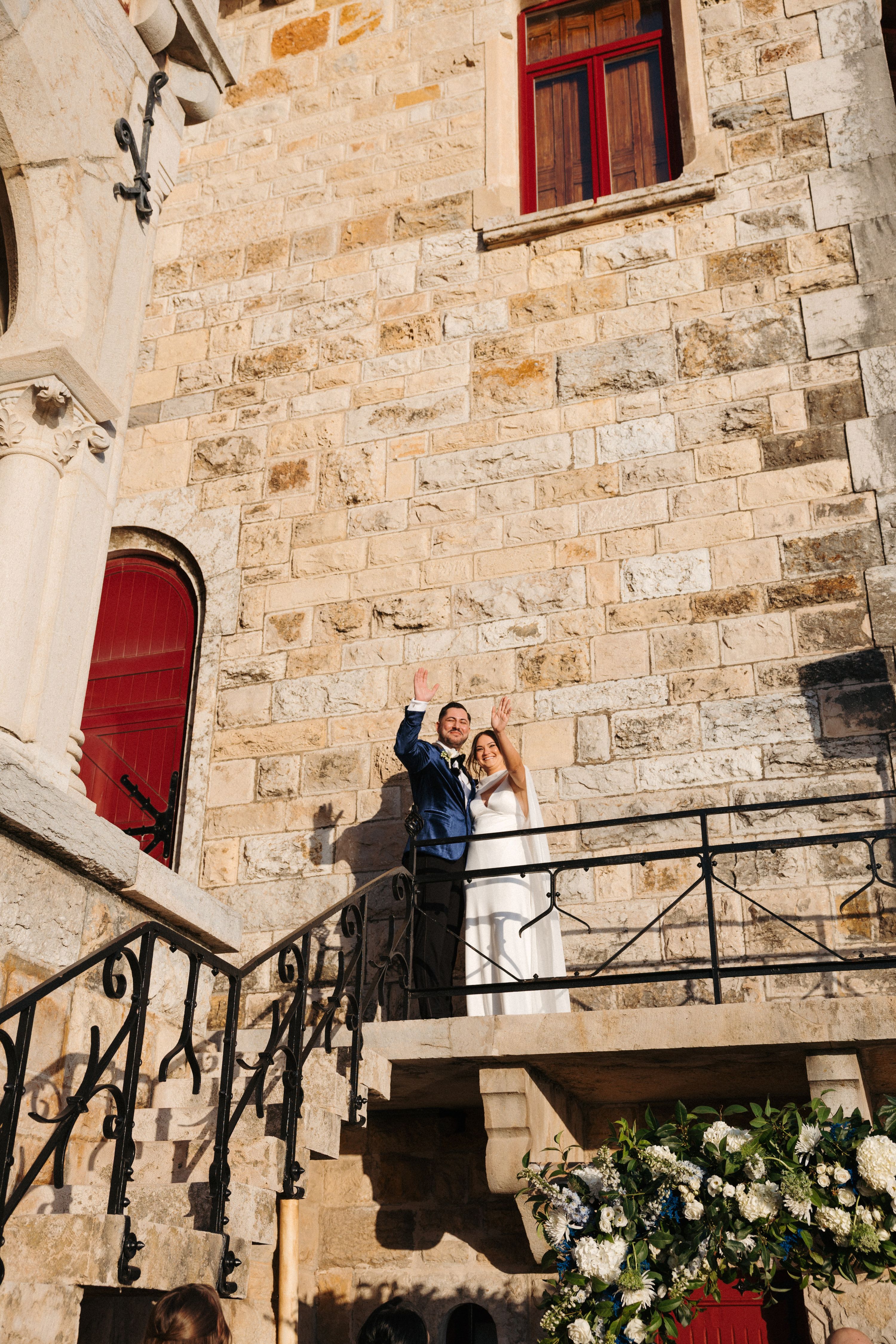 Bride and groom on top of the balcony of the castle where they had their micro wedding in Portugal