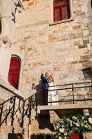 Bride and groom on top of the balcony of the castle where they had their micro wedding in Portugal