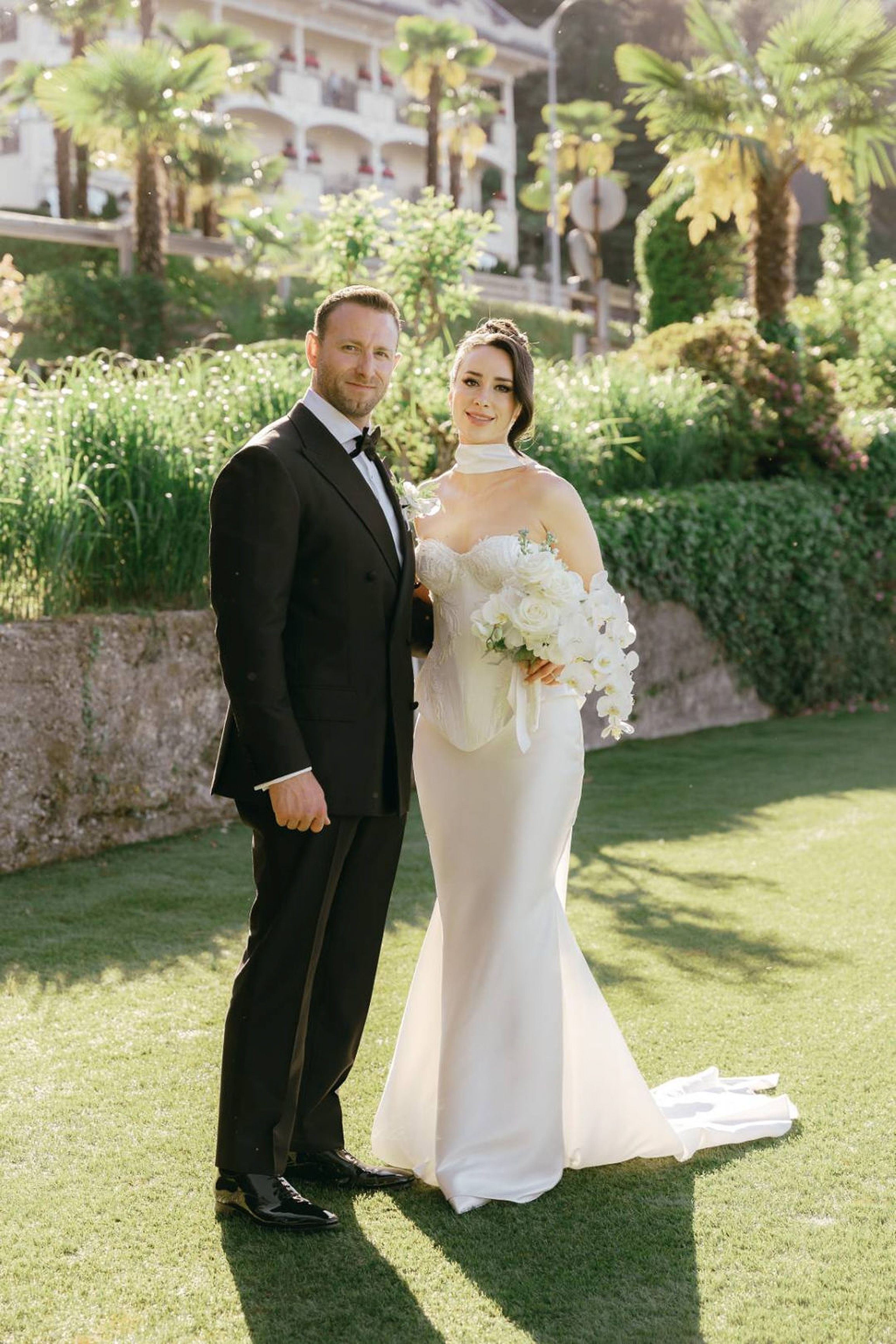 Newlyweds posing among lush hedges and historic villas at a small wedding in Italy in the Italian countryside