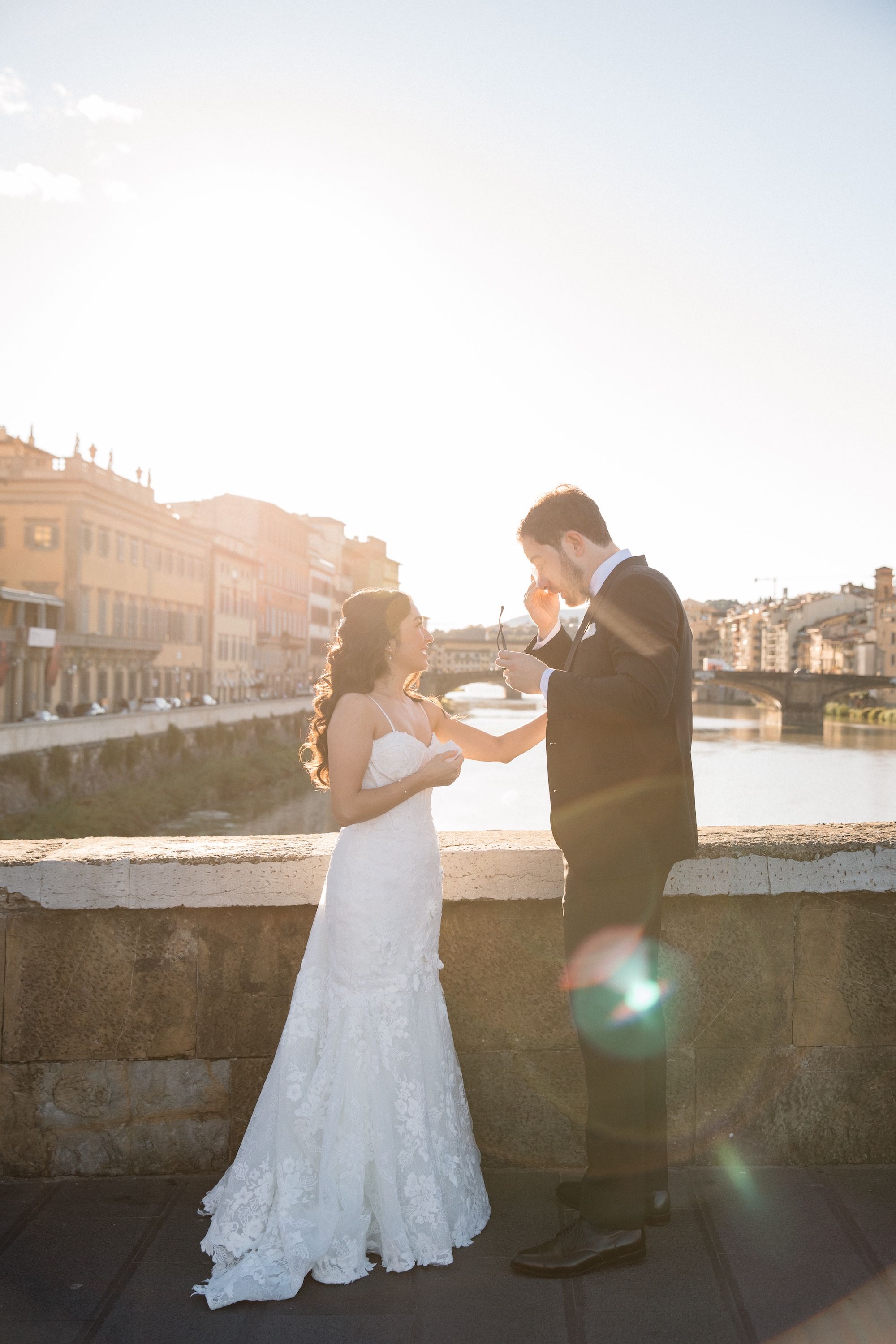 Groom wipes tears as he saw his bride during the first look of their vow renewal in Italy