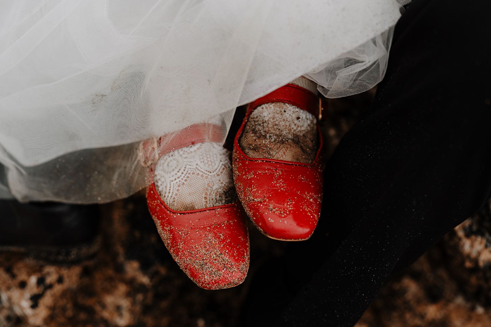 Red shoes covered in sand after an adventure elopement in Ireland