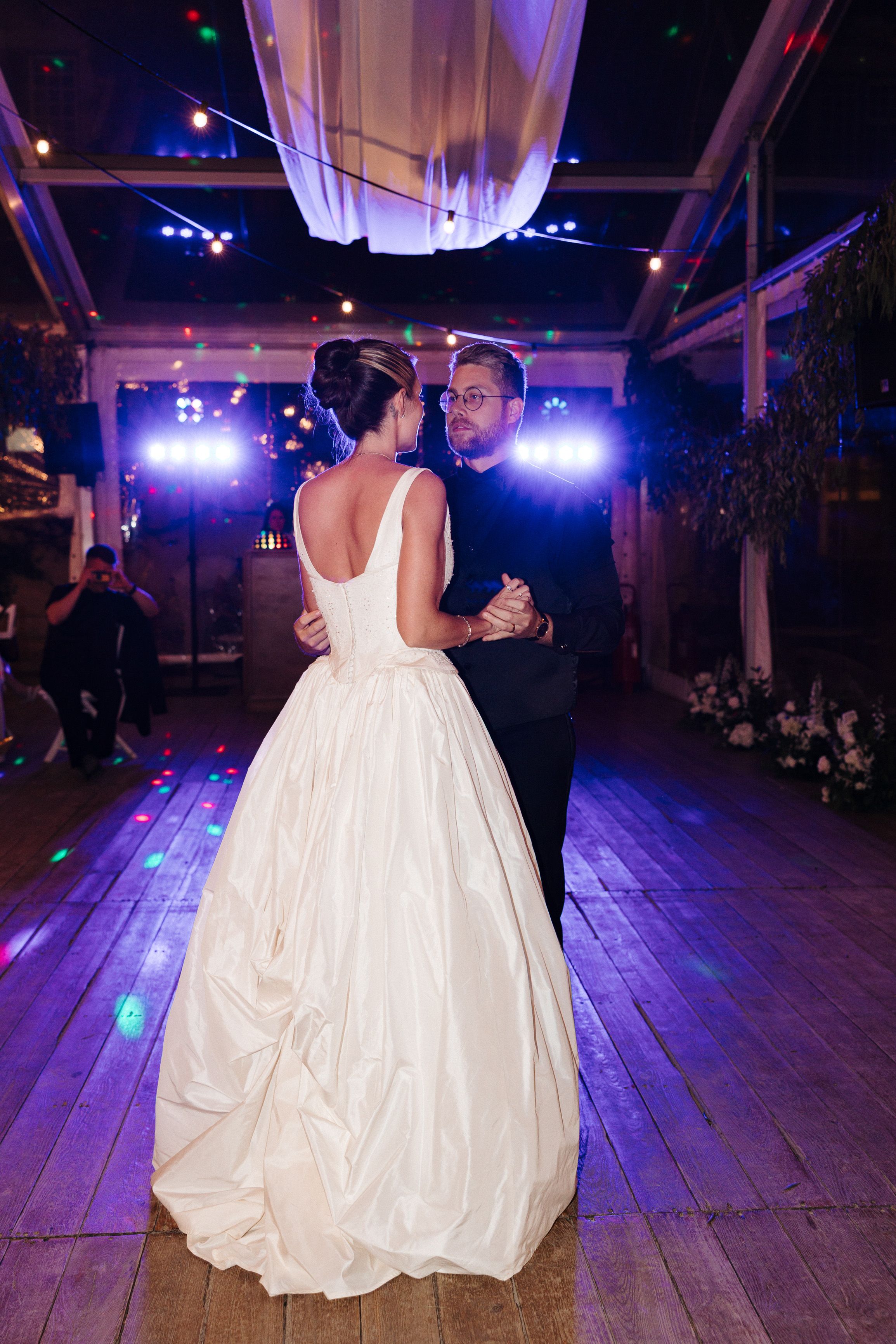Bride celebrating on the dance floor surrounded by guests at an intimate wedding in Portugal