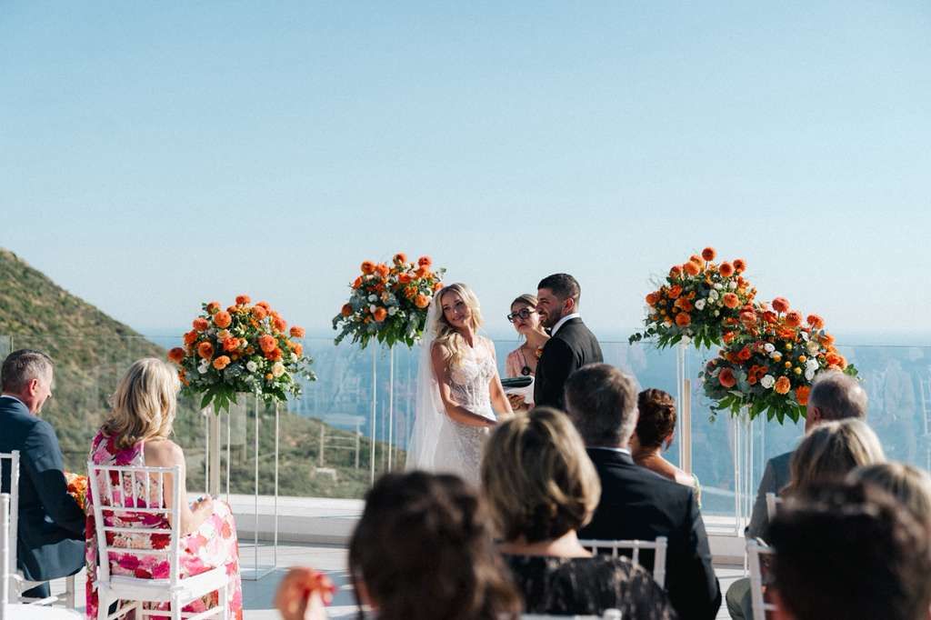 Bride and groom face their guests during the ceremony of their intimate wedding in Italy atop a terrace in Sorrento