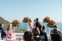 Bride and groom face their guests during the ceremony of their intimate wedding in Italy atop a terrace in Sorrento