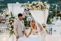 Bride and groom signing a marriage certificate at their destination wedding in Amalfi Coast