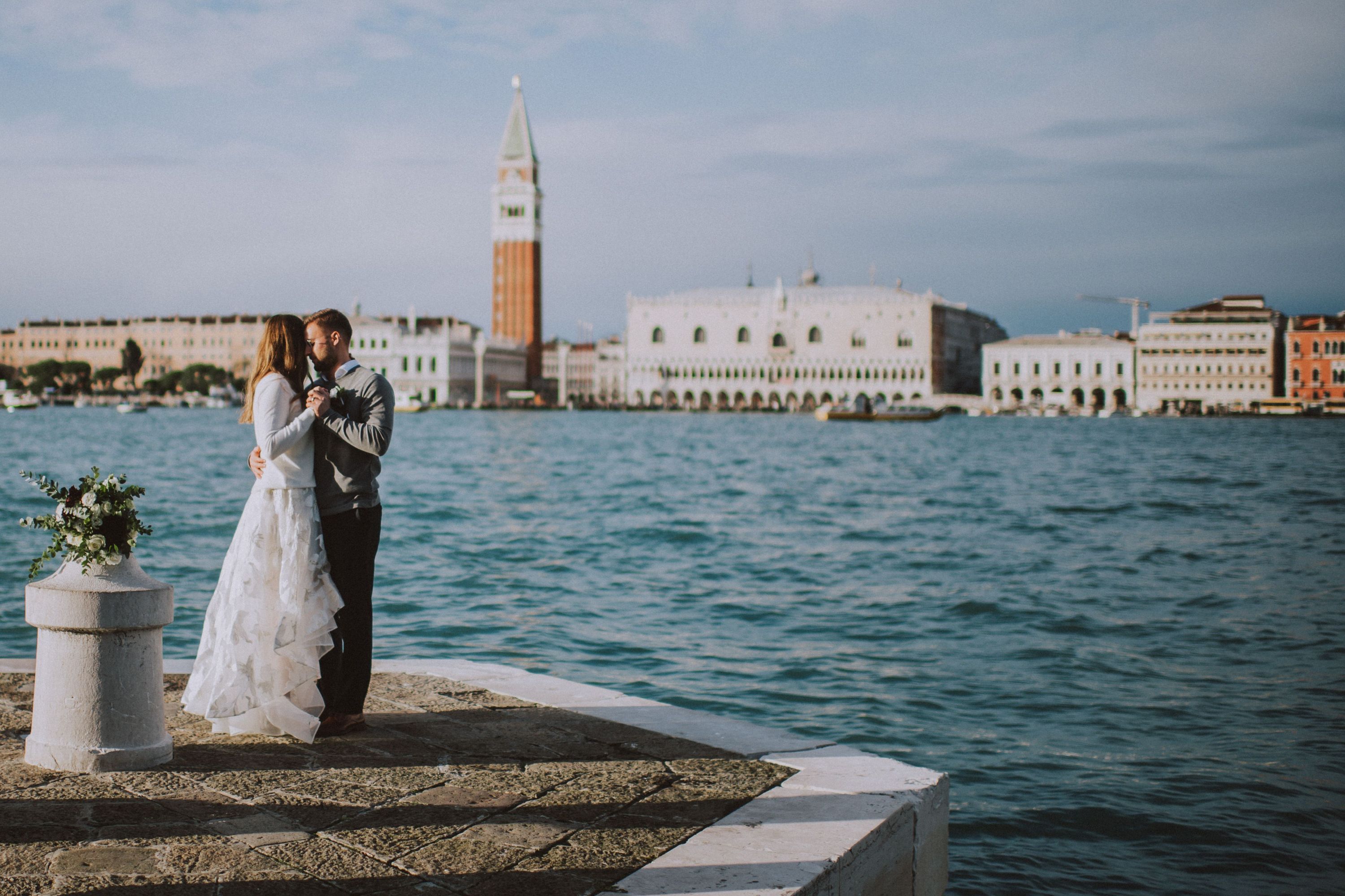 Bride and groom dancing on a platform in Venice