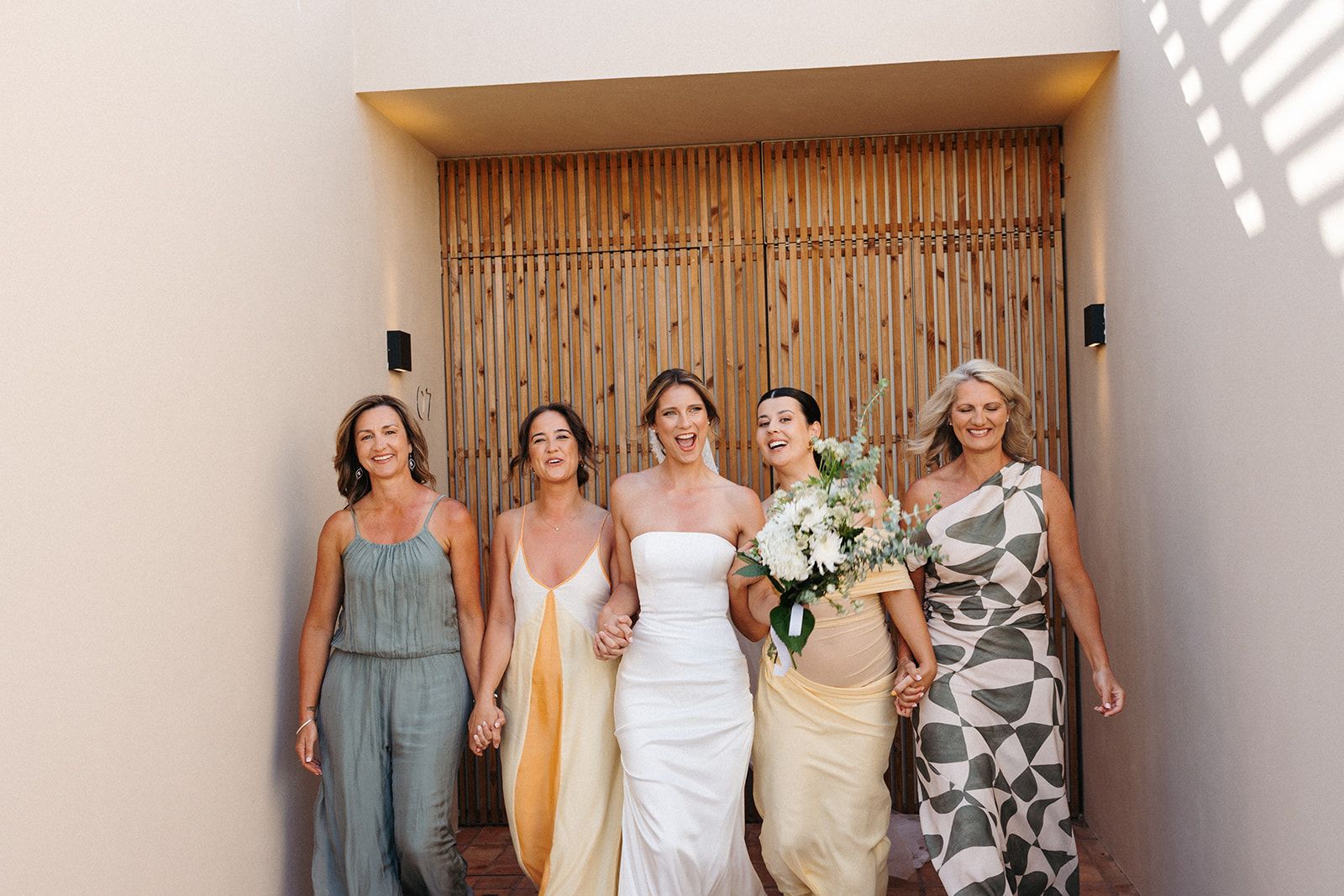 Bride with her family walking during the wedding preparation photoshoot of her destination wedding in Portugal