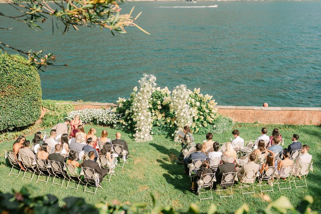 Outdoor ceremony for a destination wedding in Italy in the middle of a garden in an estate fronting Lake Como