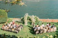 Outdoor ceremony for a destination wedding in Italy in the middle of a garden in an estate fronting Lake Como