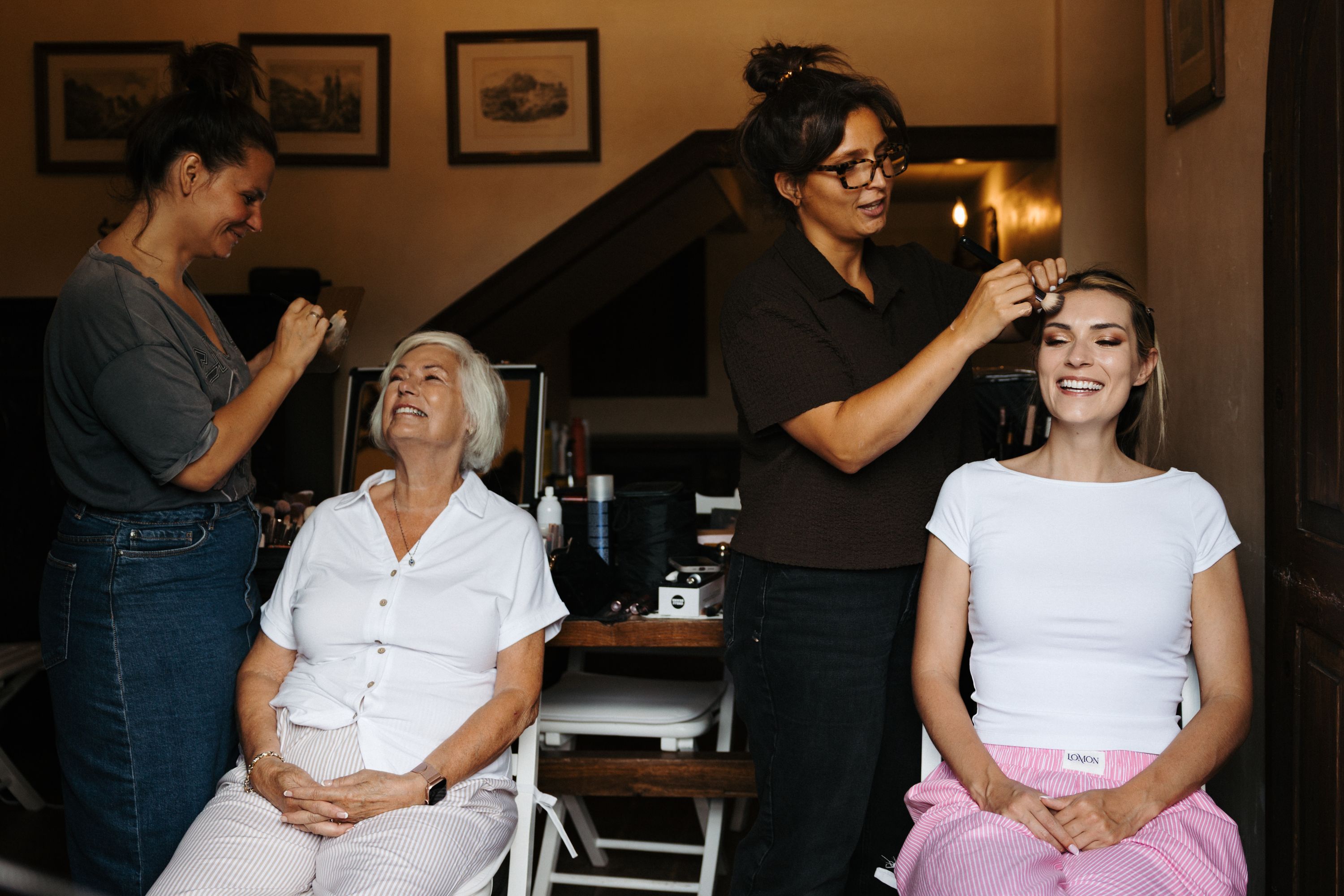 A bride and her mother being styled by a team of hair & makeup artists before a wedding in Portugal