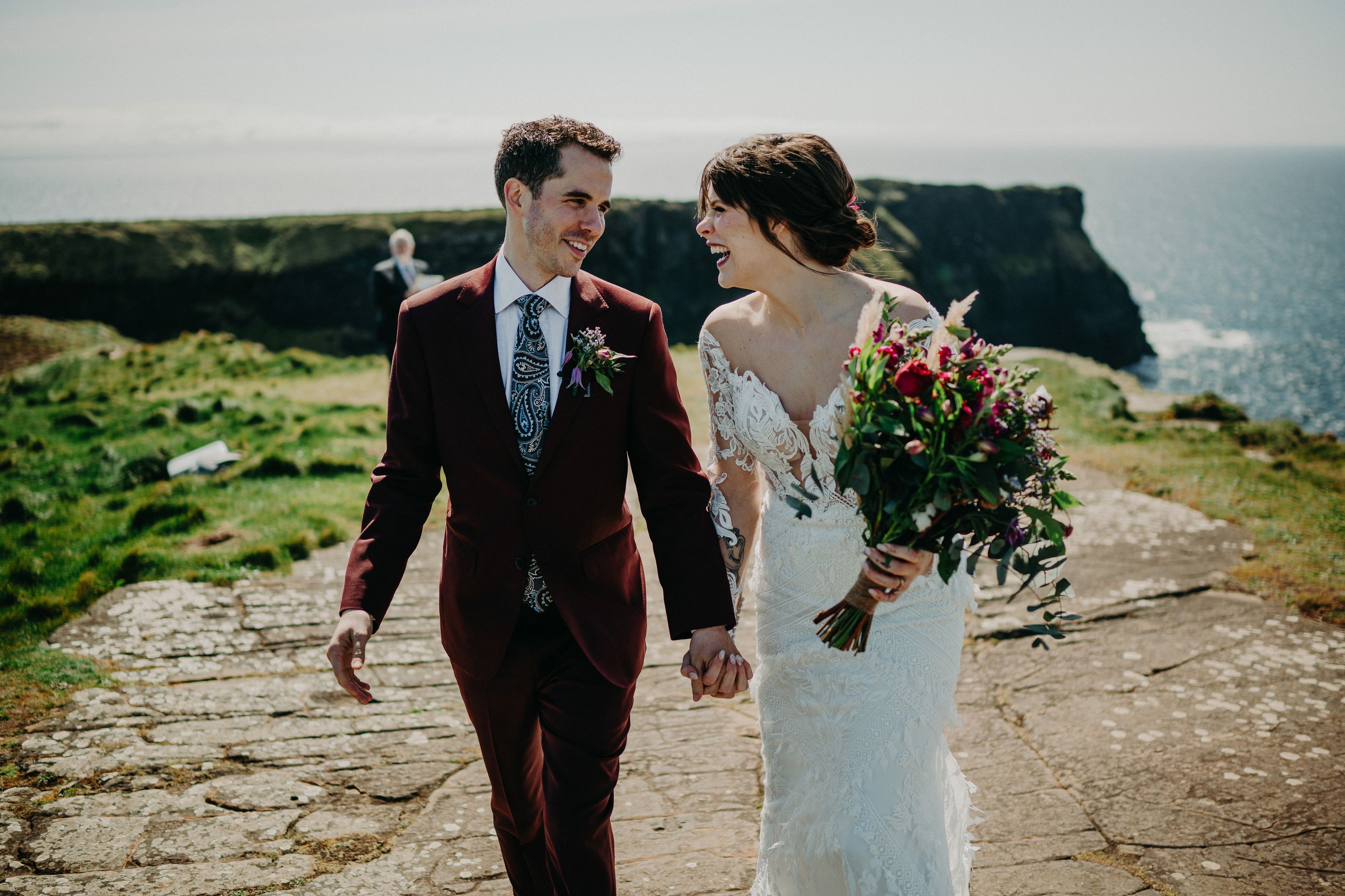 A bride and groom take a walk after their small wedding in Ireland