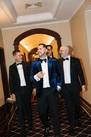 Groom relaxed and walking with his groomsmen inside the hotel where they got ready for his small wedding in Portugal
