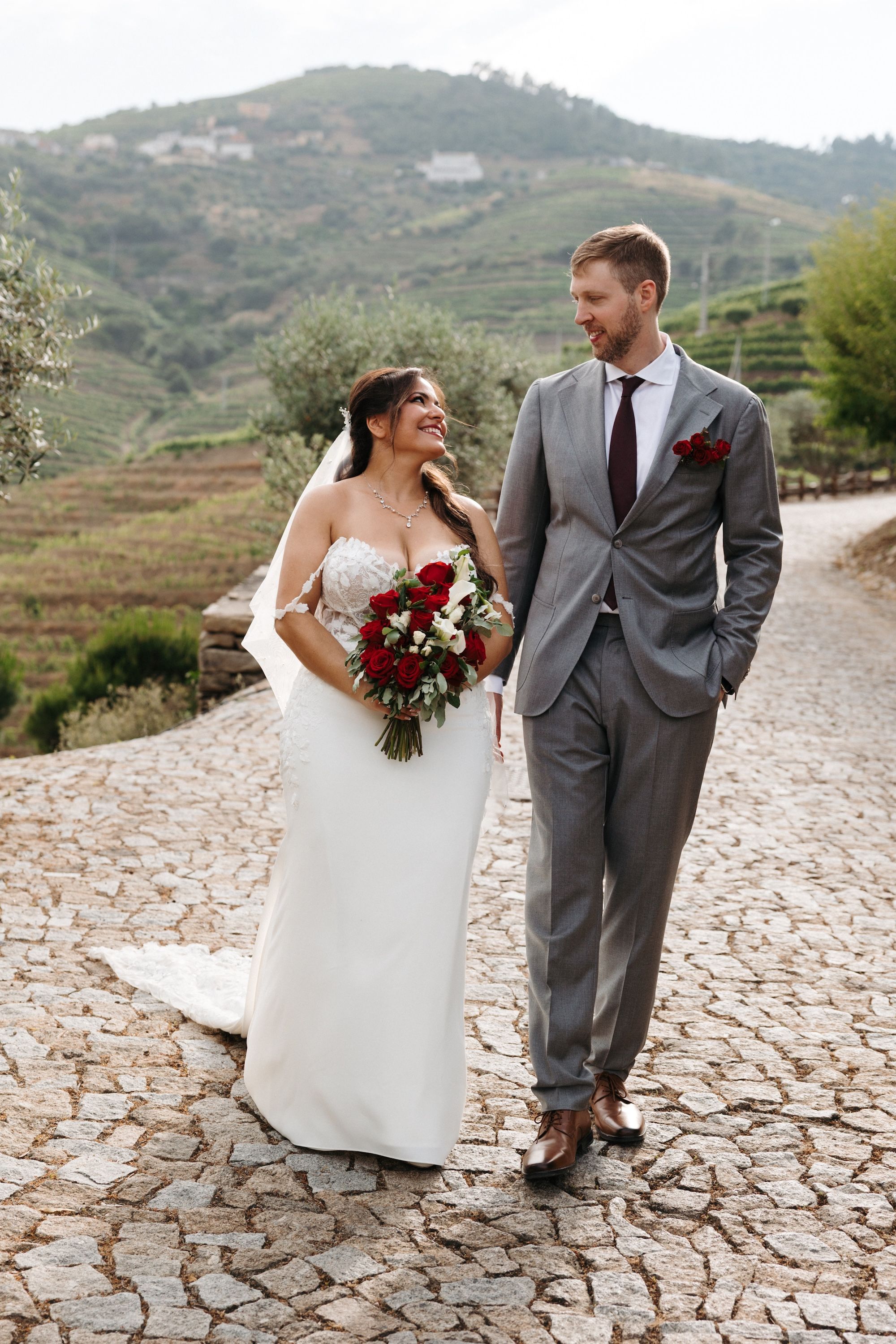 Newlyweds romantically look at each other during the outdoor photoshoot of their small wedding in Portugal