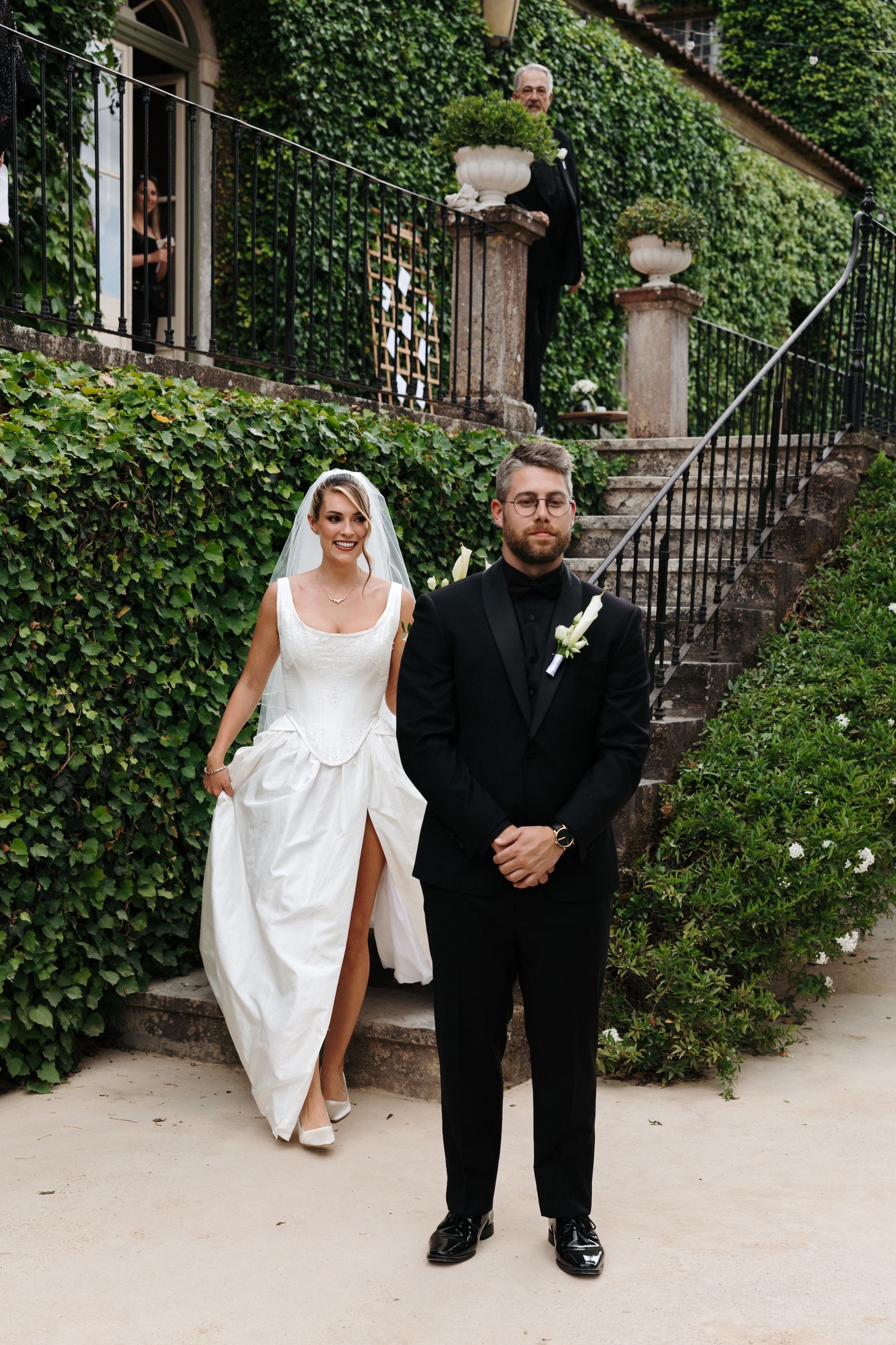 Bride smiles in excitement while she walks towards her groom during the first look of their small wedding in Portugal