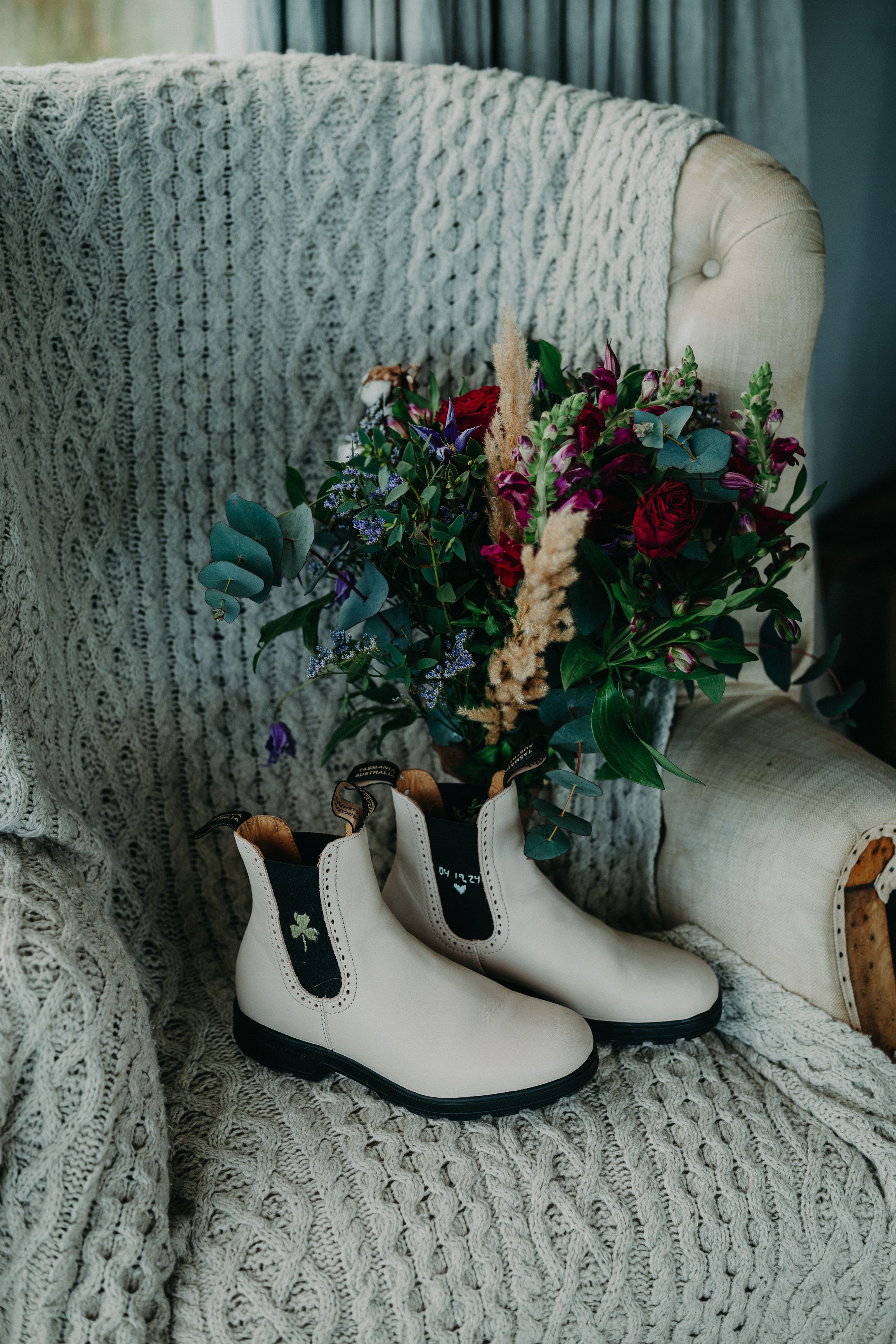 A pair of boots and a colorful bouquet for a bride about to have her intimate wedding in Ireland