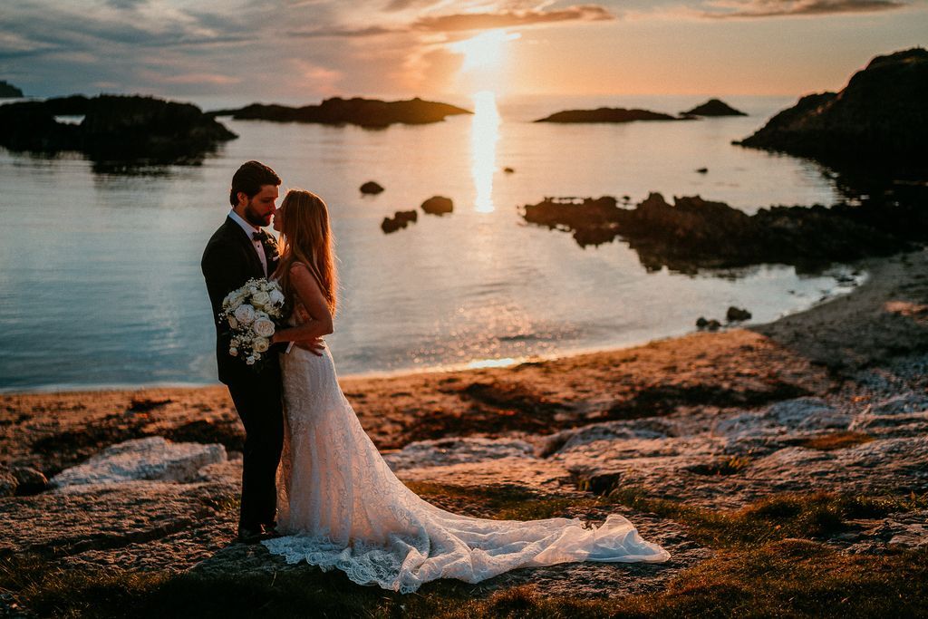 Bride and groom looking at each other and hugging at the beach during sunset while eloping in Ireland