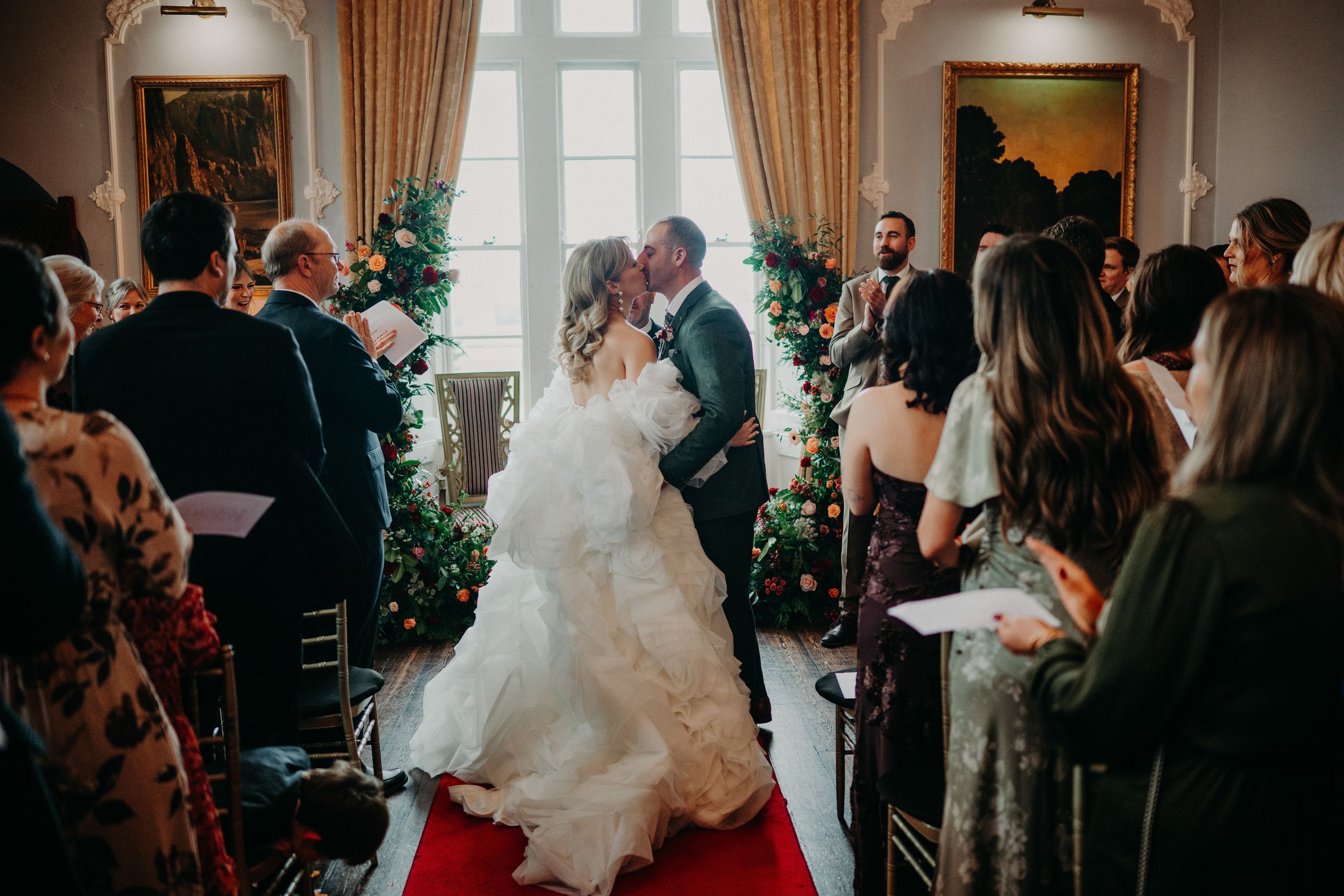 Newlyweds sharing their first kiss during an intimate wedding in Ireland ceremony