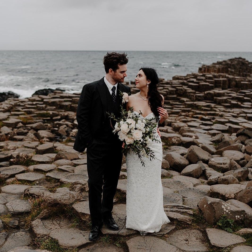 Bride and grom posing at Giant's Causeway in Northern Ireland