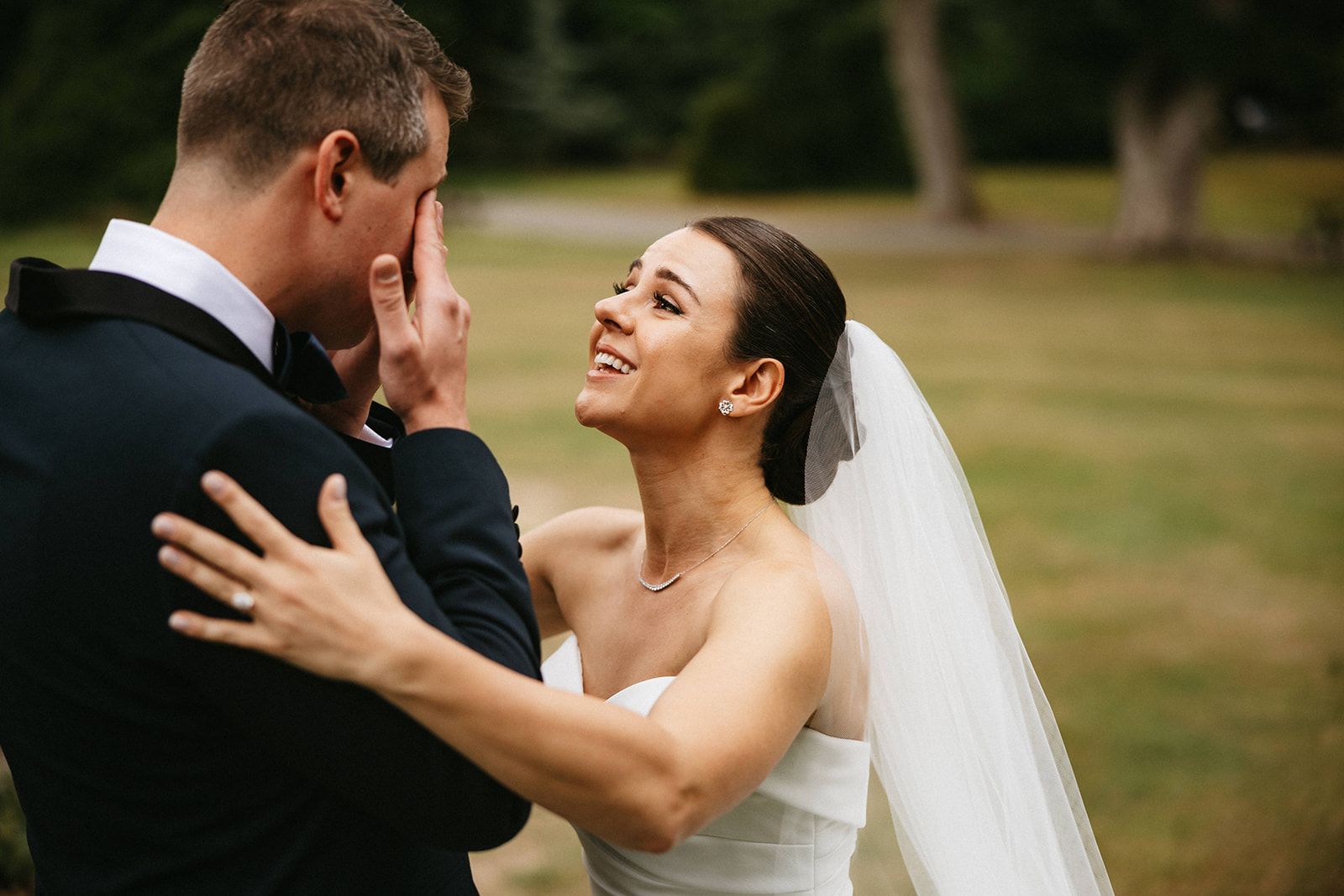 Bride looks with so much emotions to her groom who cries during the first look of their micro wedding in Ireland