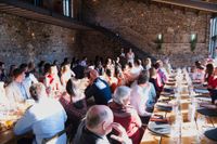 Bride and groom deliver a speech during the reception of their destination wedding in Spain in a rustic event room