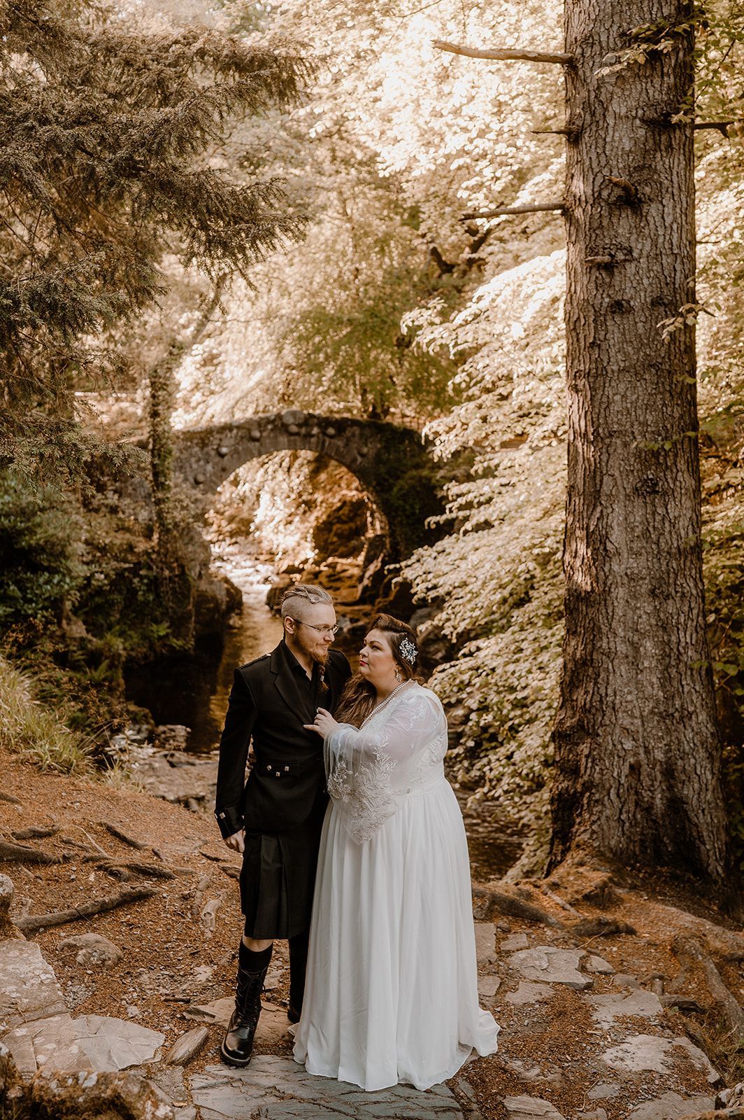 Bride and groom looking at each other during their Irish elopement photoshoot in the Tolllymore Forest park