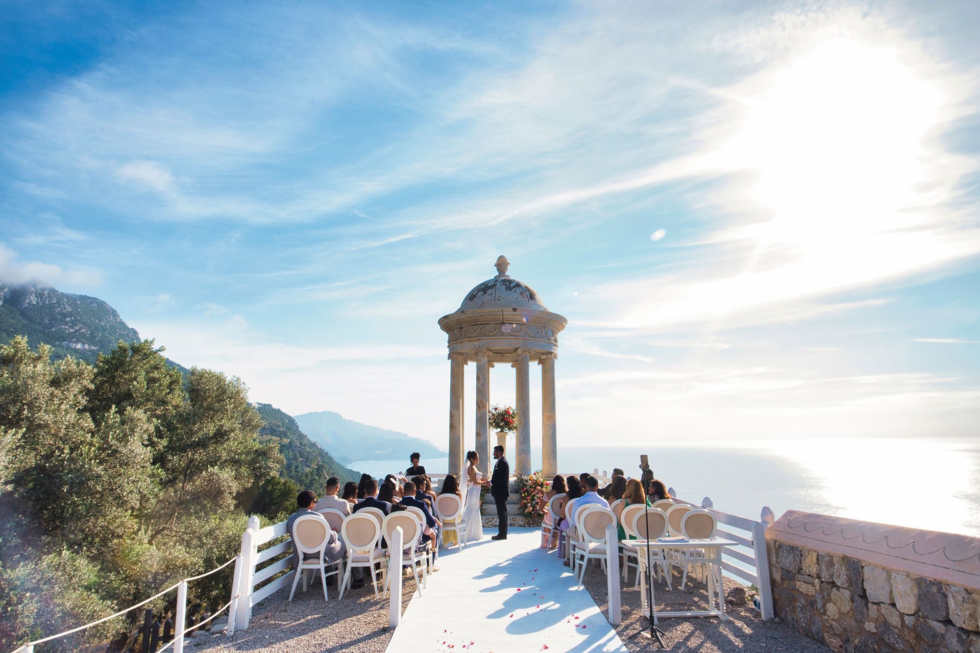 Couple holding each other’s hands during the ceremony of their destination wedding in Spain at the cliffs of Mallorca