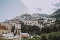 Pastel buildings perched on the hillside of the Amalfi Coast in Italy