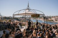 Bride and groom having a ceremony for their intimate wedding in Portugal in front of their guests on a terrace of a hotel