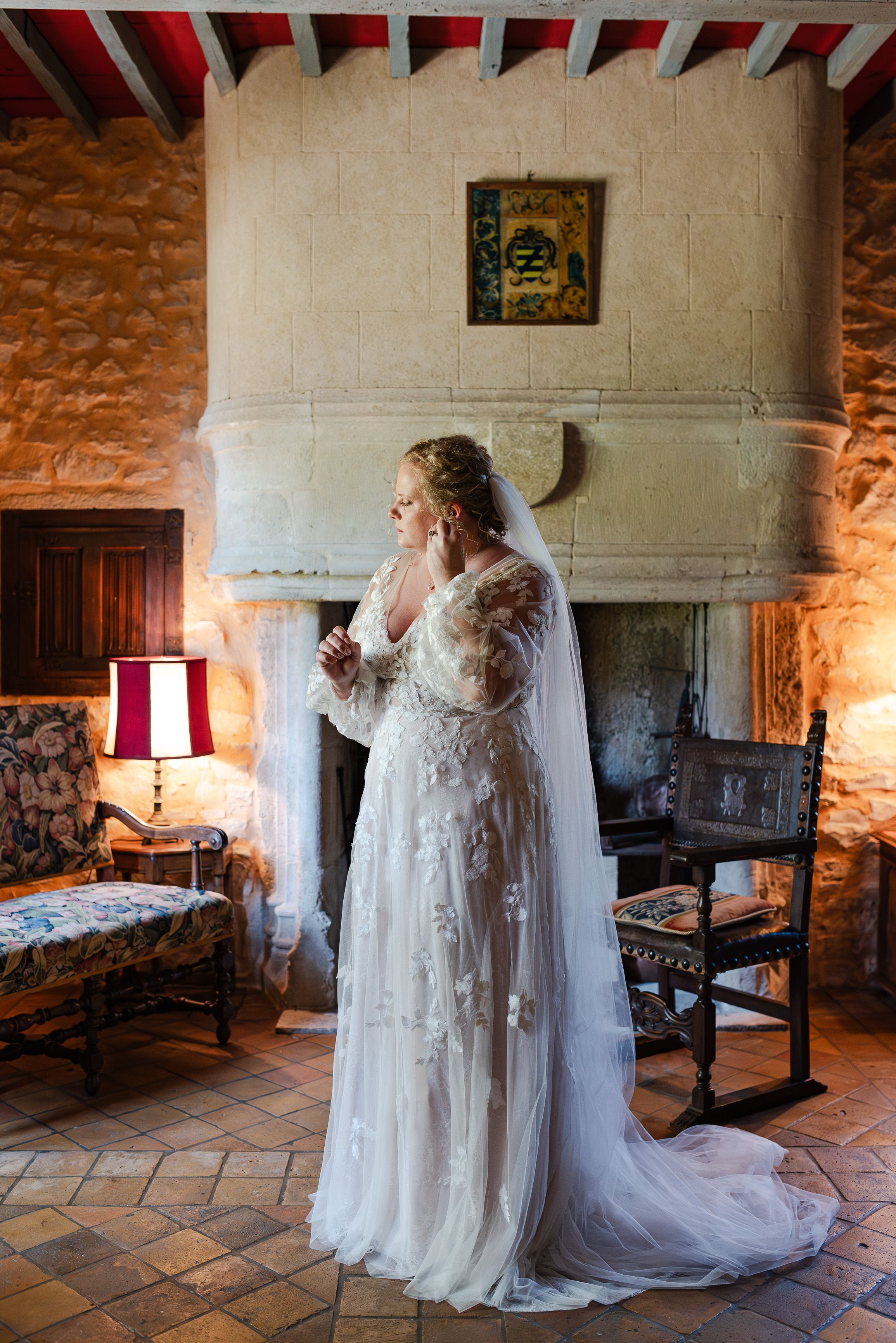 Bride getting ready in a historic French manor room for a small wedding in France