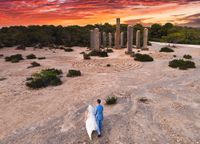 A cove in Ibiza called Cala Llentia with lush forests and a unique stone architectural work in the middle