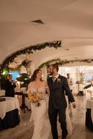 Newlyweds happily walking inside a restaurant in Amalfi Coast during the intimate dinner of their elopement in Italy