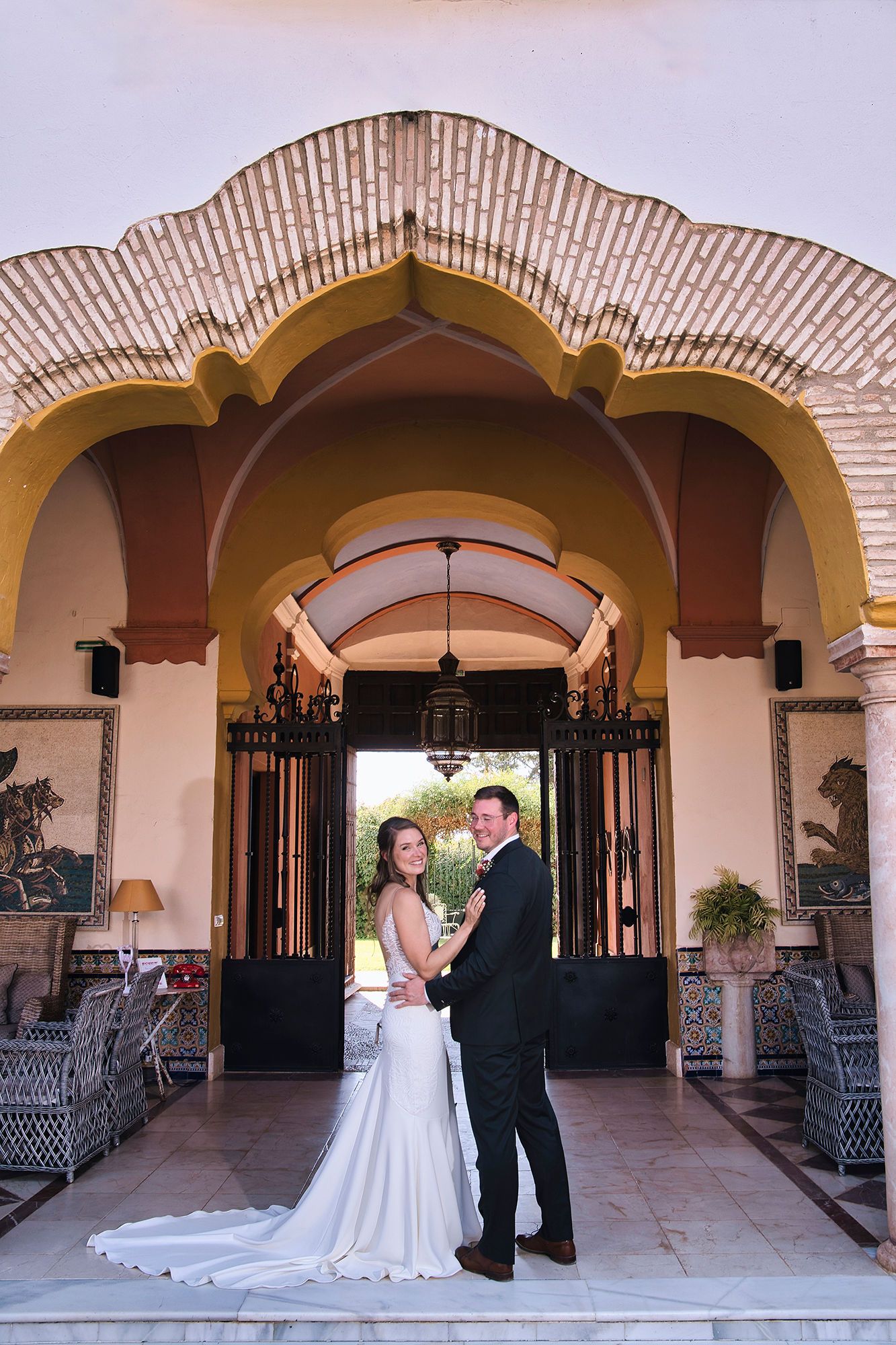Bride and groom happily looking at the camera during the photoshoot of their small wedding in Spain in a farmhouse in Cadiz