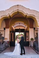Bride and groom happily looking at the camera during the photoshoot of their small wedding in Spain in a farmhouse in Cadiz