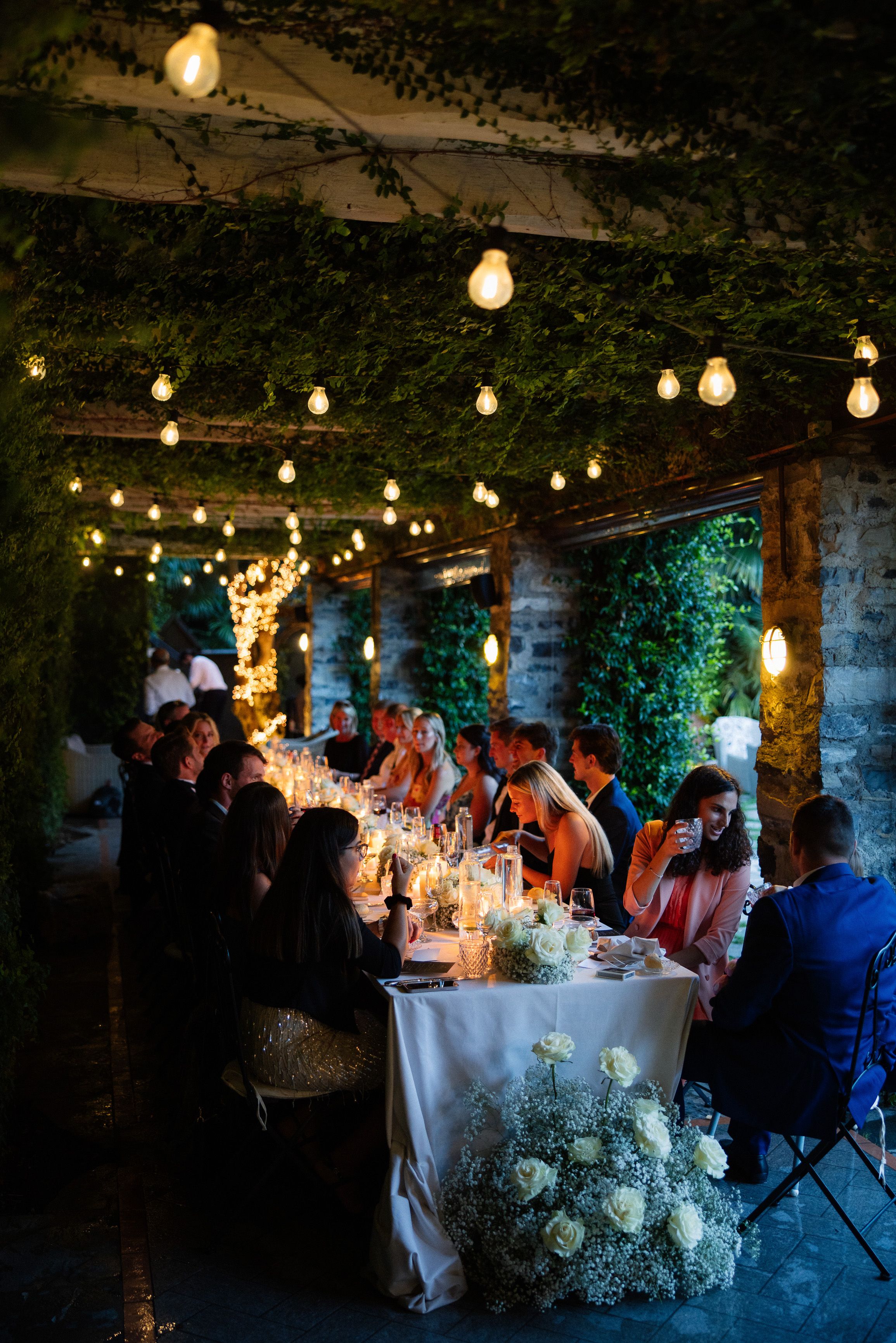A bride and groom enjoying their reception party with friends and family during their small wedding in Italy
