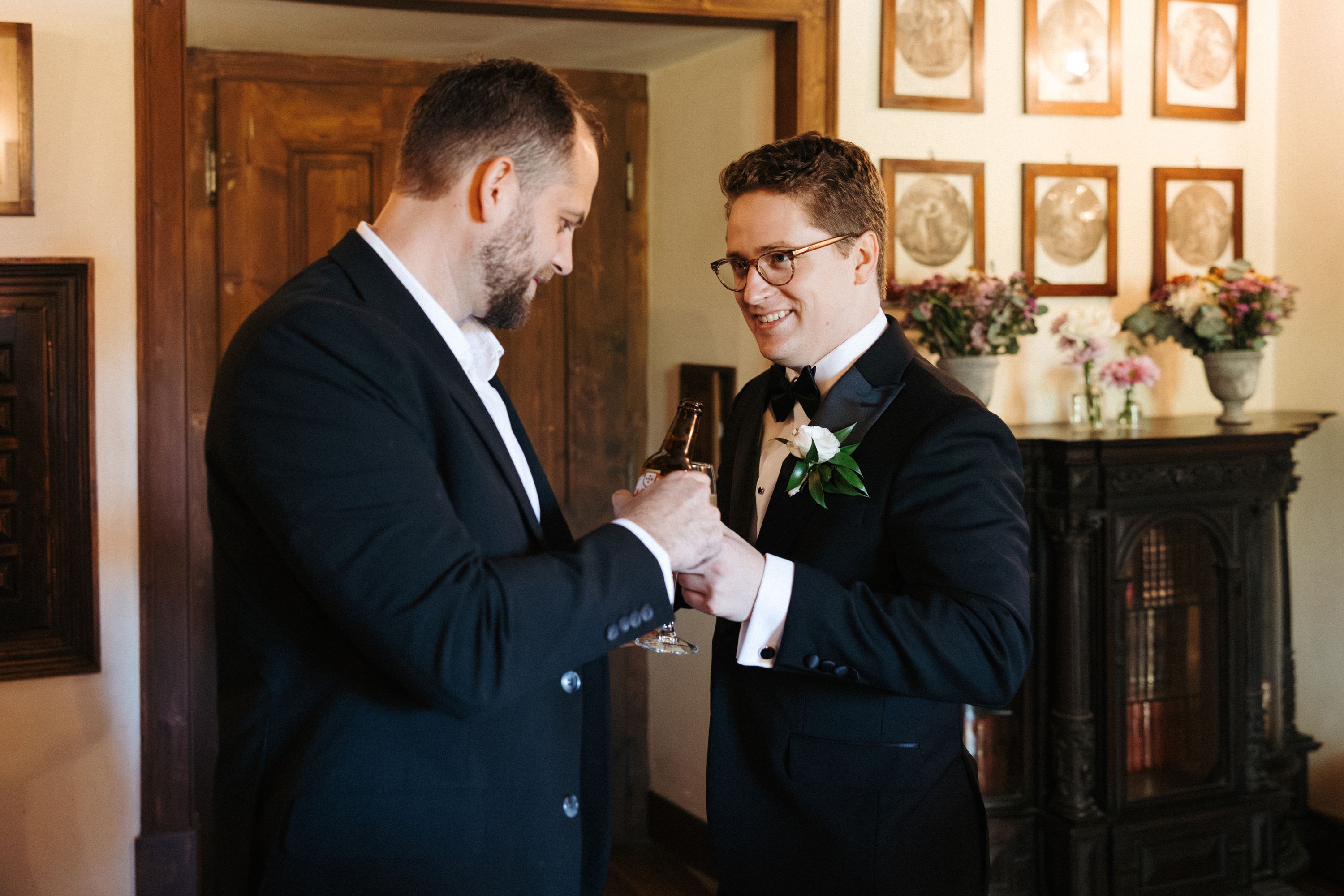 Groom sharing a celebratory toast while getting ready for an intimate wedding in Portugal
