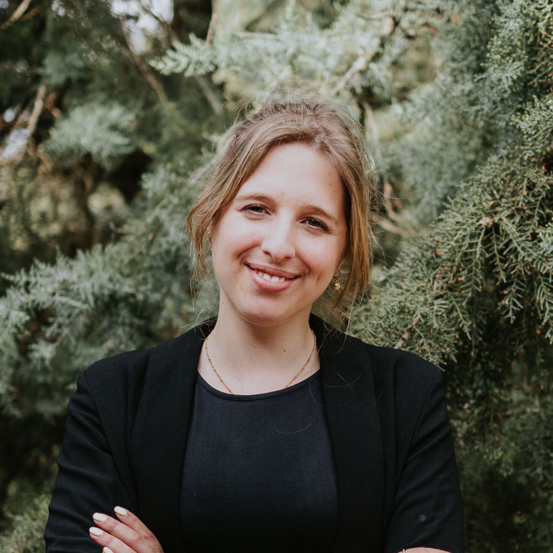 Our wedding planner in Portugal smiling for the camera with greenery in the background