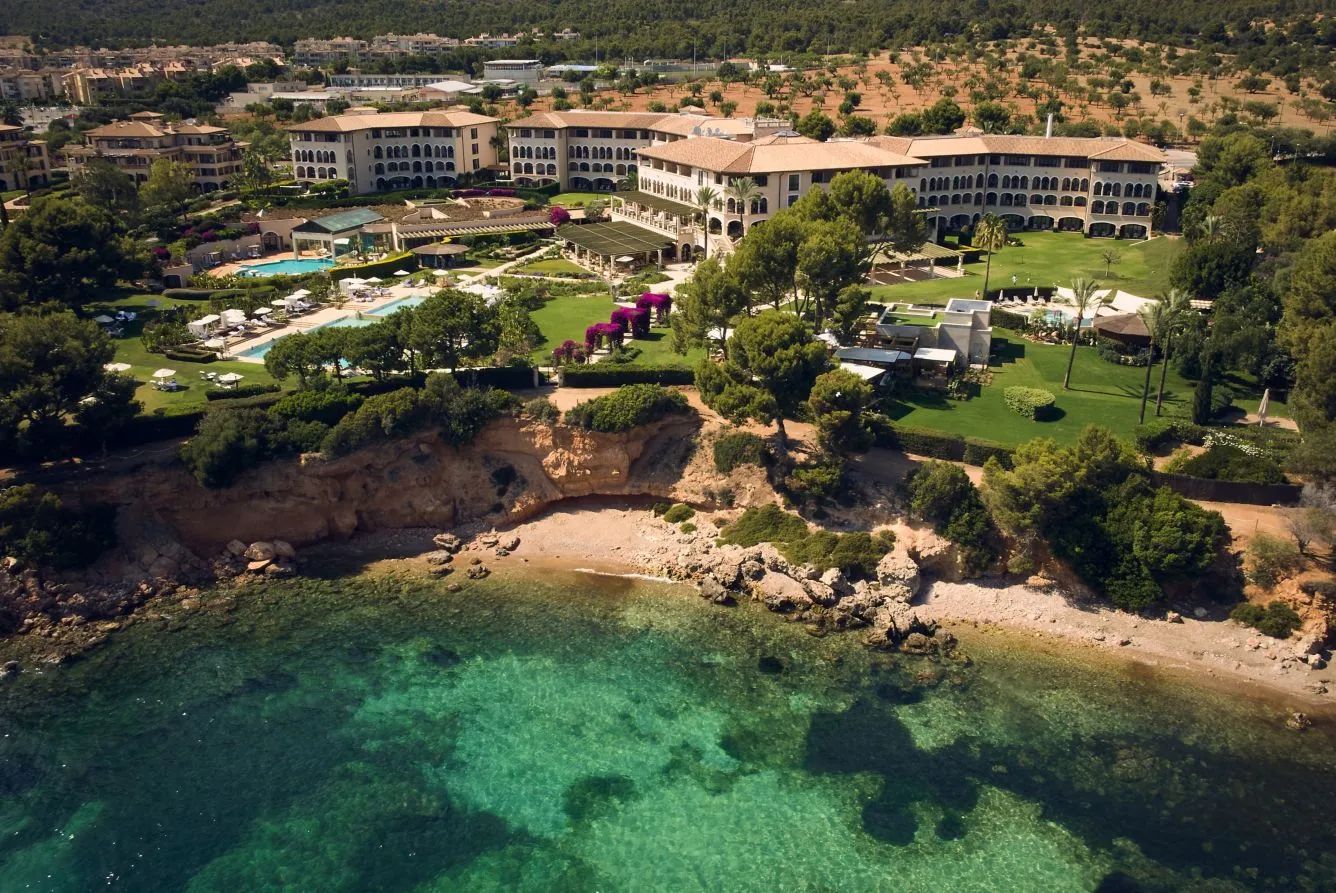 Mallorcan landscape with sandy shores and cliffs and lush greenery dotted with hotels