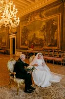Bride and groom having a ceremony in a historic hall of a museum and national monument for their vow renewal in Italy