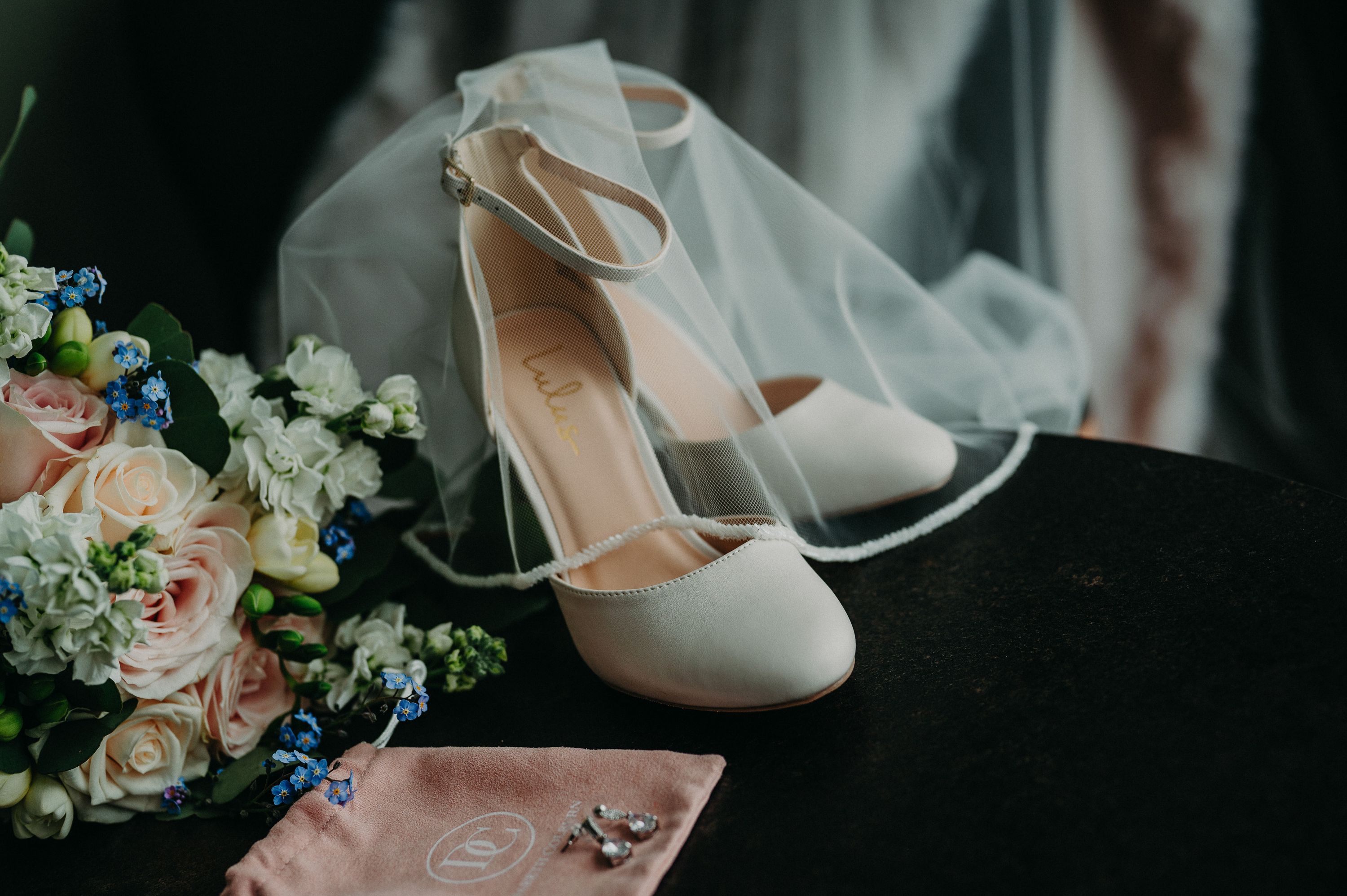 Bridal shoes, veil, bouquet, and earrings styled together for an intimate wedding in Portugal
